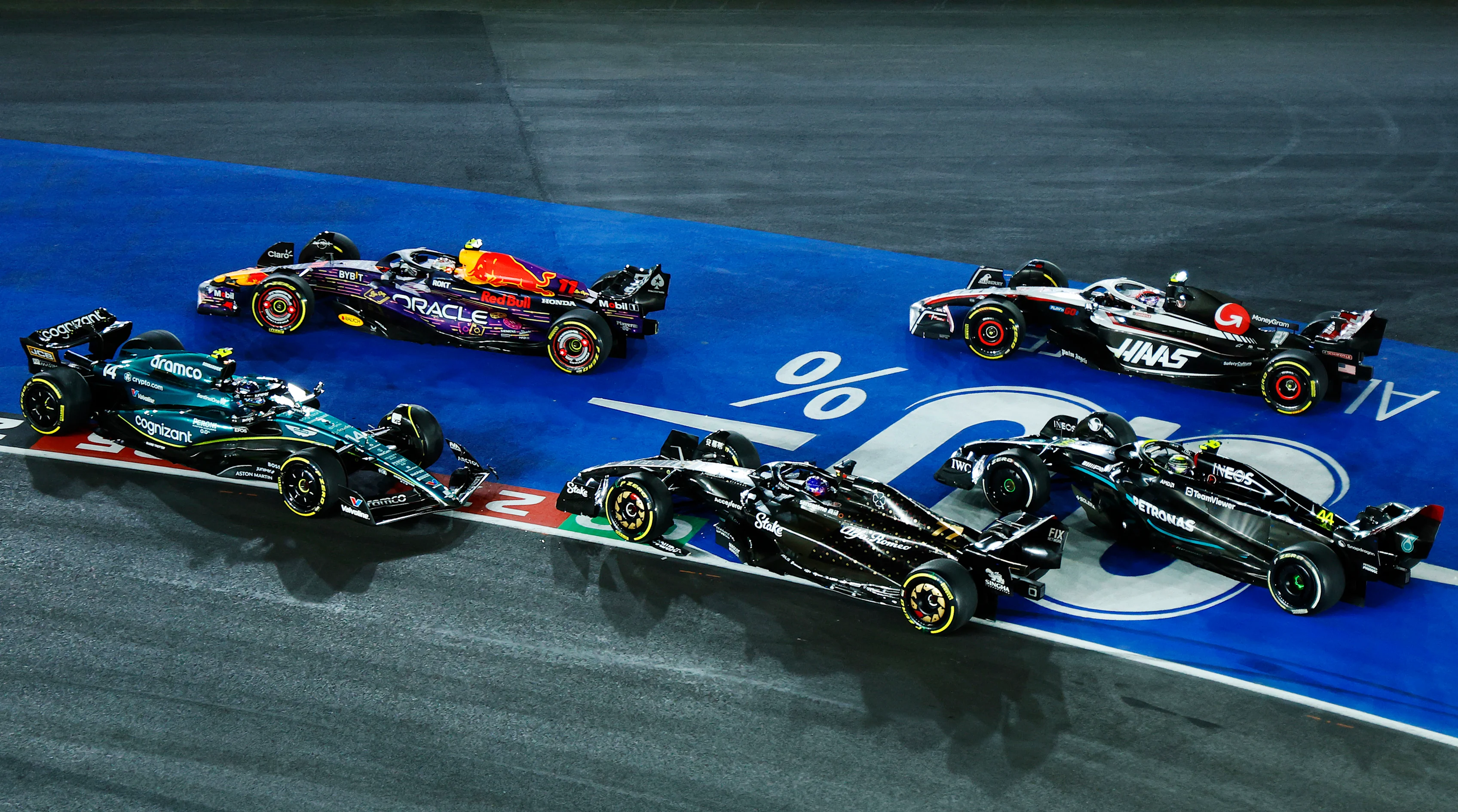 LAS VEGAS, NEVADA - NOVEMBER 18: Fernando Alonso of Spain driving the (14) Aston Martin AMR23 Mercedes and Valtteri Bottas of Finland driving the (77) Alfa Romeo F1 C43 Ferrari collide at turn one during the F1 Grand Prix of Las Vegas at Las Vegas Strip Circuit on November 18, 2023 in Las Vegas, Nevada. (Photo by Chris Graythen/Getty Images)