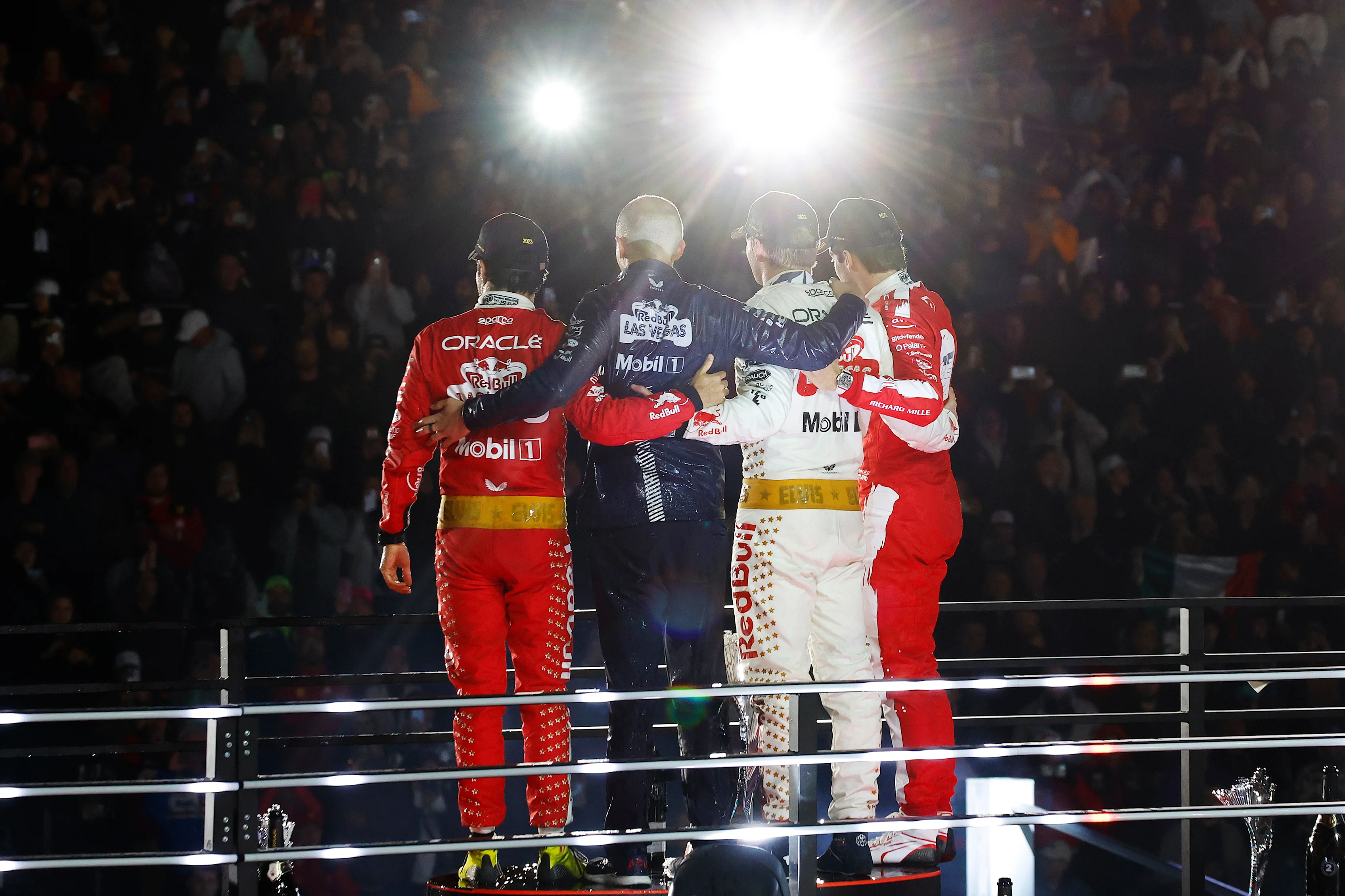 LAS VEGAS, NEVADA - NOVEMBER 18: Race winner Max Verstappen of the Netherlands and Oracle Red Bull Racing, Second placed Charles Leclerc of Monaco and Ferrari and Third placed Sergio Perez of Mexico and Oracle Red Bull Racing celebrate on the podium during the F1 Grand Prix of Las Vegas at Las Vegas Strip Circuit on November 18, 2023 in Las Vegas, Nevada. (Photo by Chris Graythen/Getty Images)