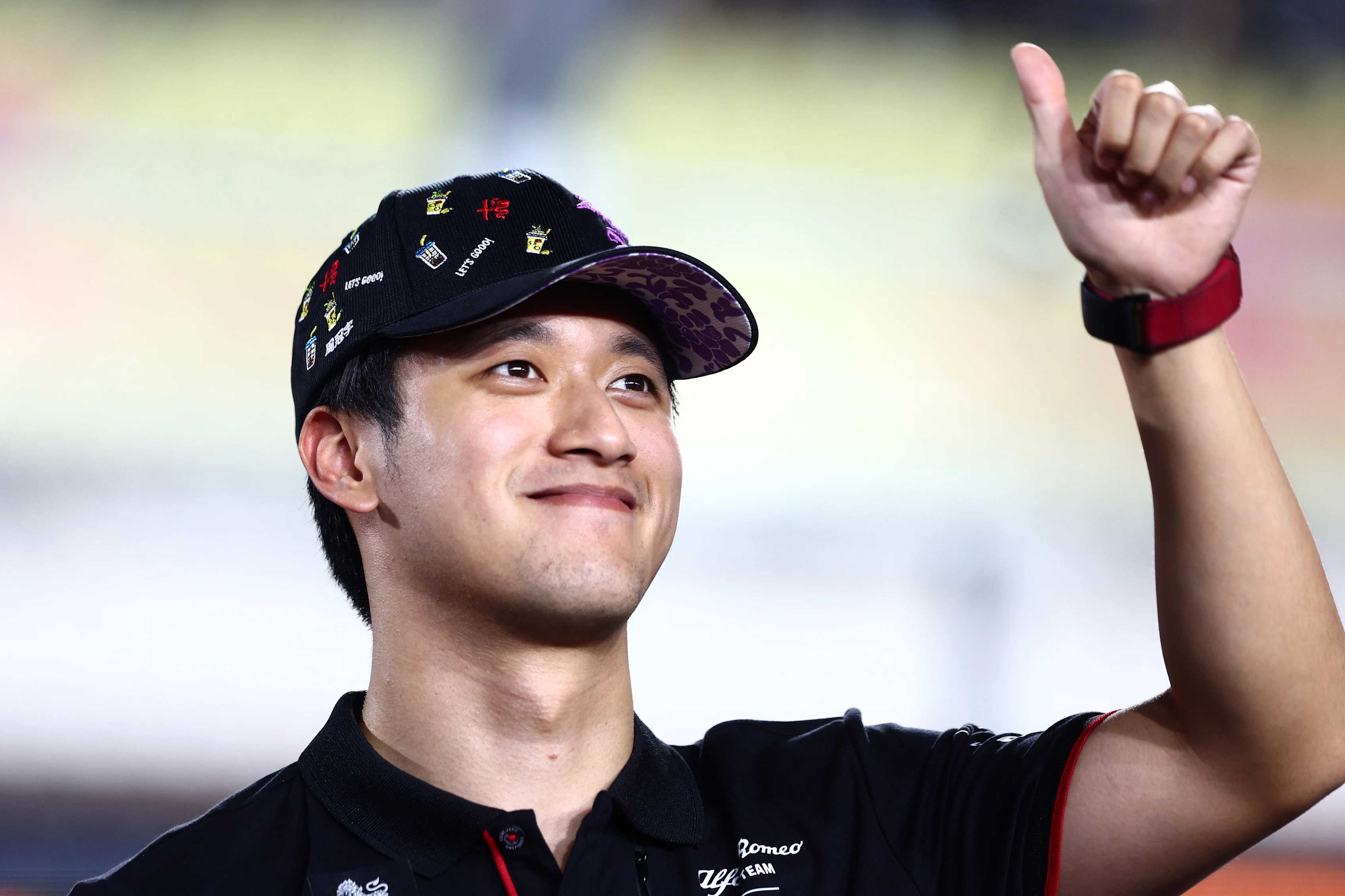 LUSAIL CITY, QATAR - OCTOBER 08: Zhou Guanyu of China and Alfa Romeo F1 waves to the crowd on the
