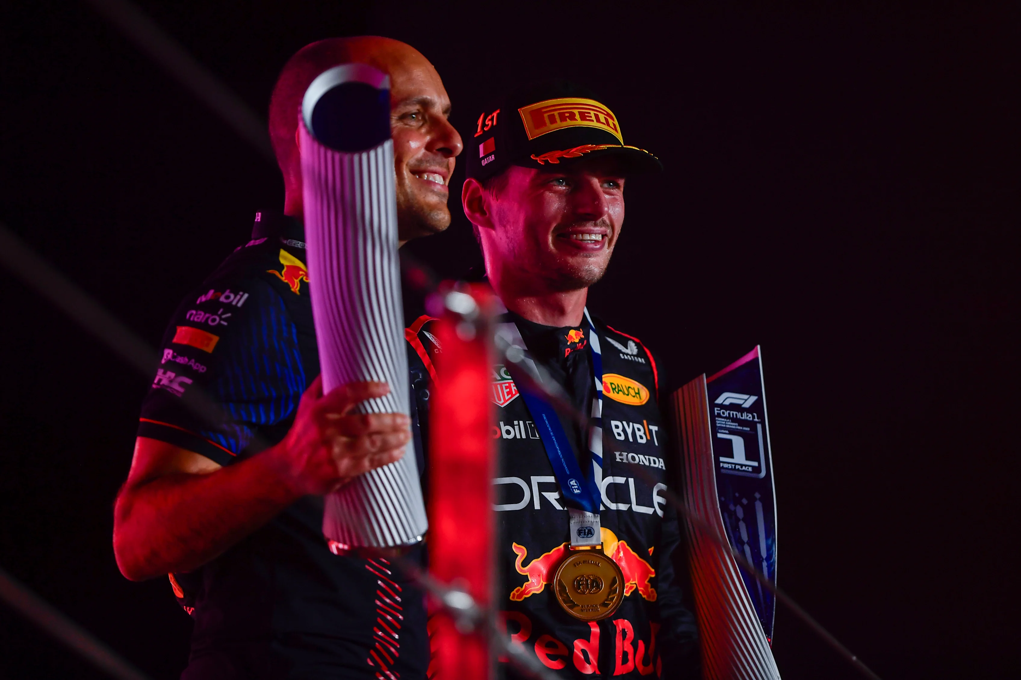 LUSAIL CITY, QATAR - OCTOBER 08: Race winner Max Verstappen of the Netherlands and Oracle Red Bull Racing and race engineer Gianpiero Lambiase celebrate on the podium during the F1 Grand Prix of Qatar at Lusail International Circuit on October 08, 2023 in Lusail City, Qatar. (Photo by Rudy Carezzevoli/Getty Images)