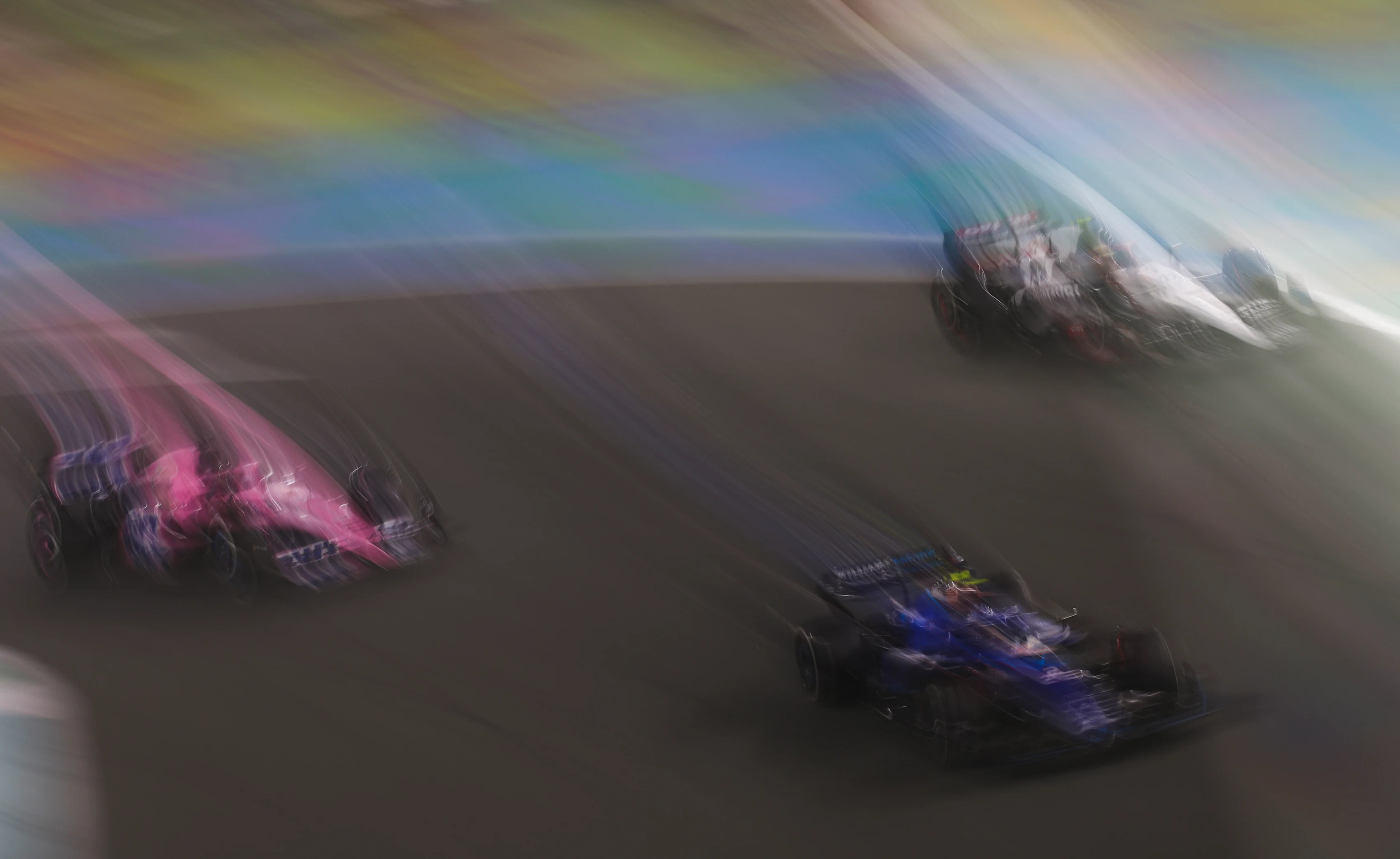 JEDDAH, SAUDI ARABIA - MARCH 19: Logan Sargeant of United States driving the (2) Williams FW45 Mercedes leads Esteban Ocon of France driving the (31) Alpine F1 A523 Renault and Yuki Tsunoda of Japan driving the (22) Scuderia AlphaTauri AT04 during the F1 Grand Prix of Saudi Arabia at Jeddah Corniche Circuit on March 19, 2023 in Jeddah, Saudi Arabia. (Photo by Lars Baron/Getty Images)