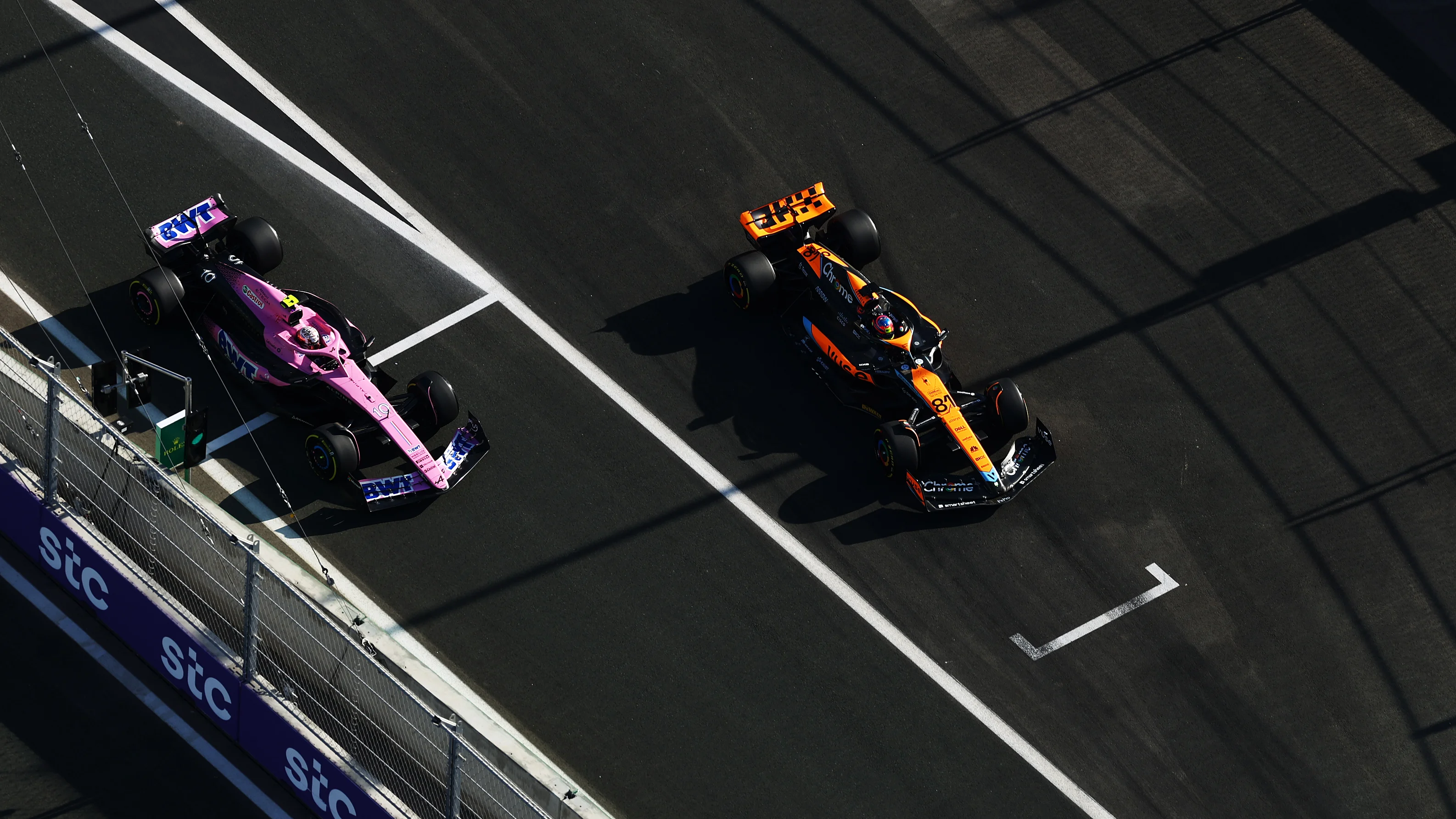 JEDDAH, SAUDI ARABIA - MARCH 17: (L) Pierre Gasly of France driving the (10) Alpine F1 A523 Renault alongside Oscar Piastri of Australia driving the (81) McLaren MCL60 Mercedes during practice ahead of the F1 Grand Prix of Saudi Arabia at Jeddah Corniche Circuit on March 17, 2023 in Jeddah, Saudi Arabia. (Photo by Bryn Lennon - Formula 1/Formula 1 via Getty Images)