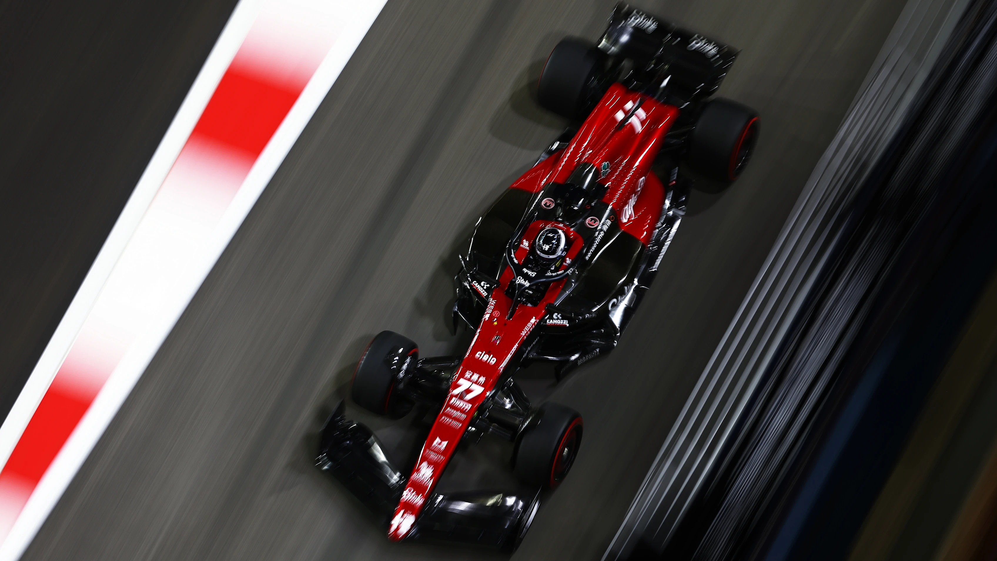 SINGAPORE, SINGAPORE - SEPTEMBER 17: Valtteri Bottas of Finland driving the (77) Alfa Romeo F1 C43 Ferrari on his way to the grid prior to the F1 Grand Prix of Singapore at Marina Bay Street Circuit on September 17, 2023 in Singapore, Singapore. (Photo by Bryn Lennon - Formula 1/Formula 1 via Getty Images)