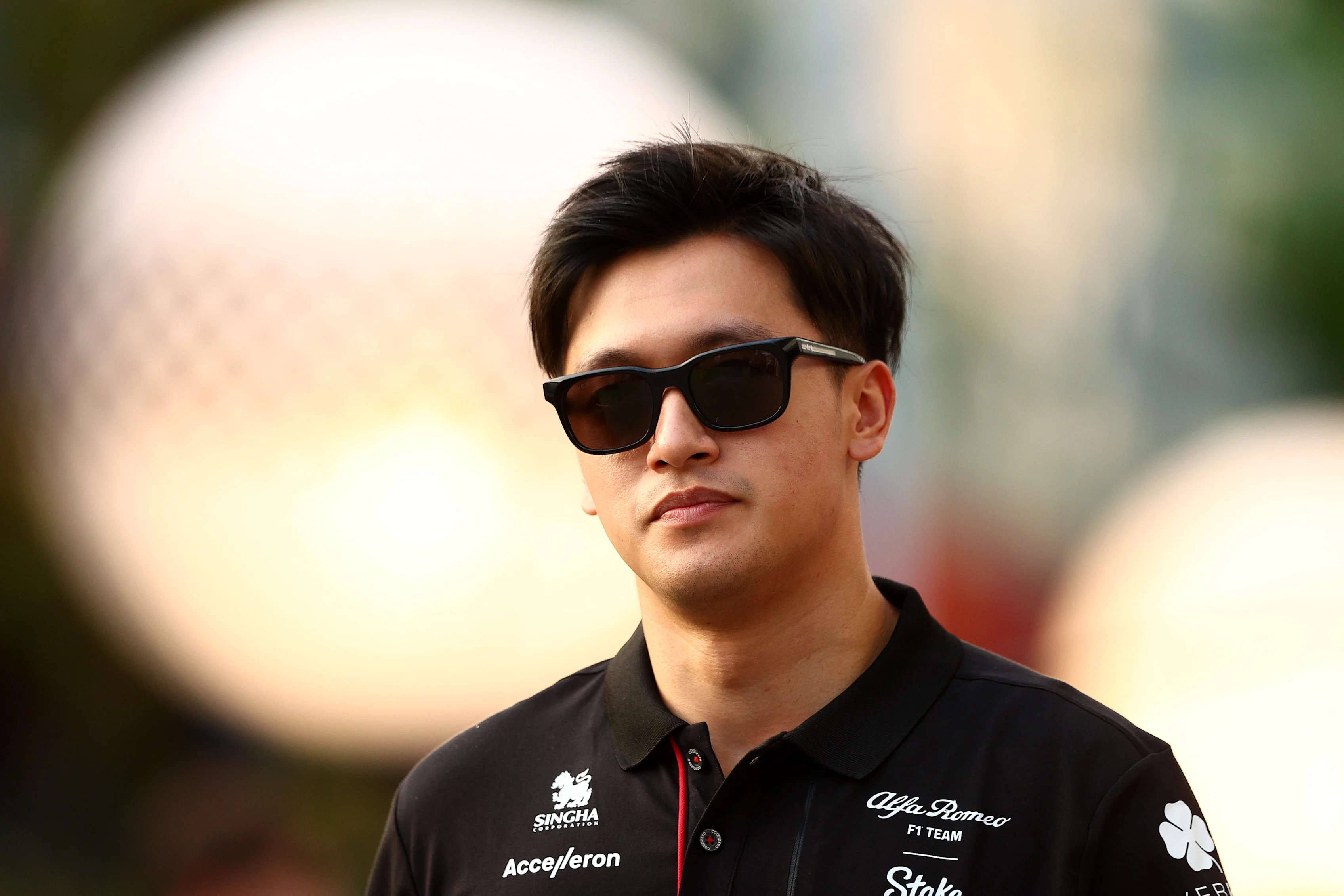 SINGAPORE, SINGAPORE - SEPTEMBER 14: Zhou Guanyu of China and Alfa Romeo F1 walks in the Paddock