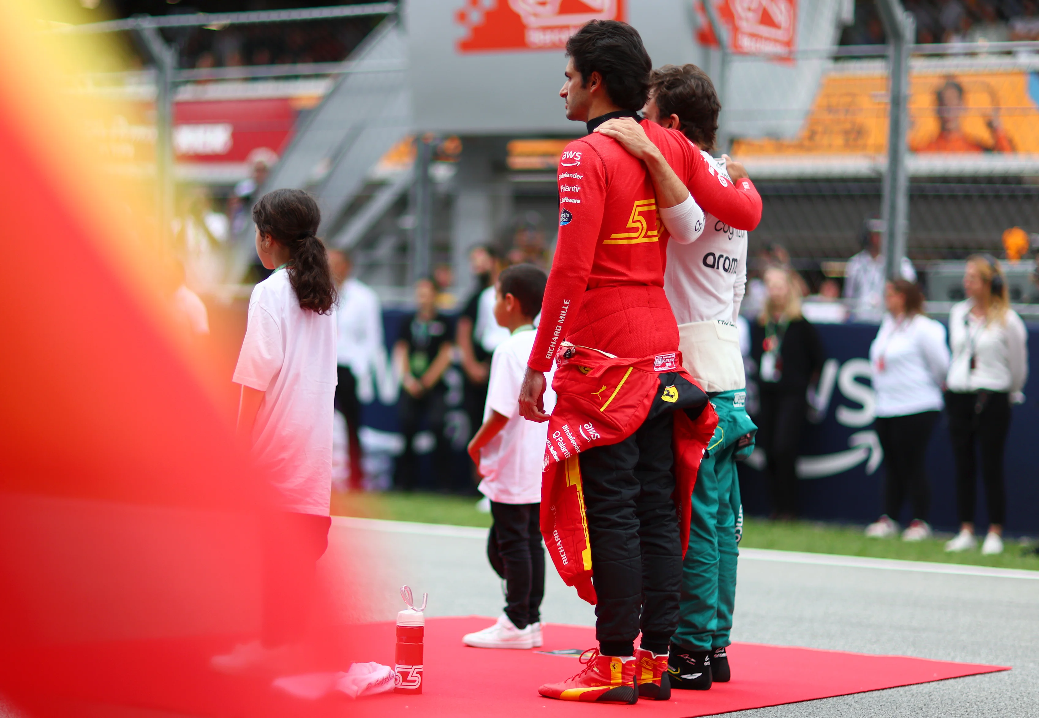 BARCELONA, SPAIN - JUNE 04: Carlos Sainz of Spain and Ferrari and Fernando Alonso of Spain and Aston Martin F1 Team interact on the grid prior to the F1 Grand Prix of Spain at Circuit de Barcelona-Catalunya on June 04, 2023 in Barcelona, Spain. (Photo by Dan Istitene - Formula 1/Formula 1 via Getty Images)