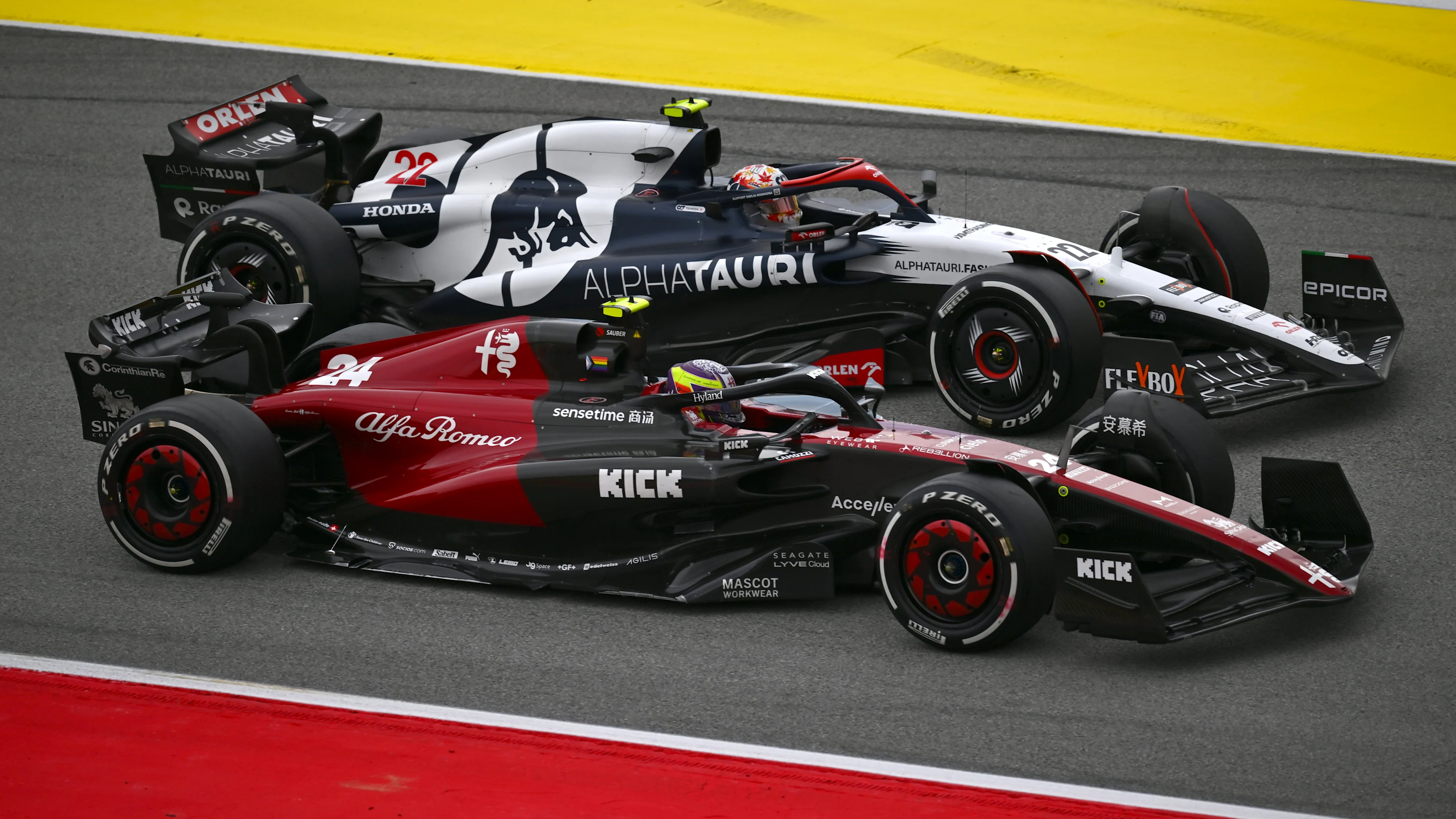 BARCELONA, SPAIN - JUNE 04: Zhou Guanyu of China driving the (24) Alfa Romeo F1 C43 Ferrari and Yuki Tsunoda of Japan driving the (22) Scuderia AlphaTauri AT04 battle for position during the F1 Grand Prix of Spain at Circuit de Barcelona-Catalunya on June 04, 2023 in Barcelona, Spain. (Photo by Dan Mullan - Formula 1/Formula 1 via Getty Images)