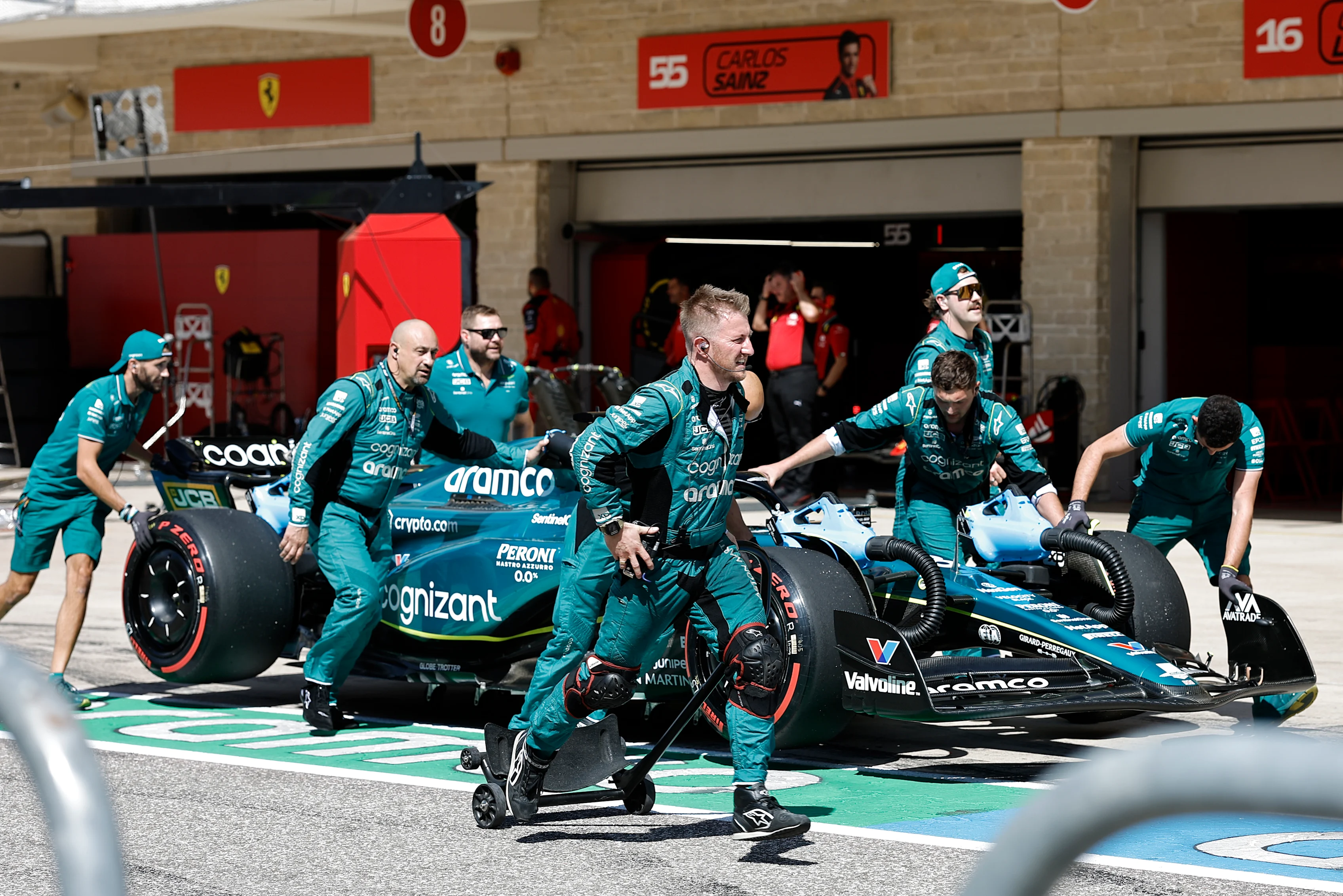 AUSTIN, TEXAS - OCTOBER 22: Aston Martin mechanics push Lance Stroll of Canada and Aston Martin F1 Team in the Pitlane prior to the F1 Grand Prix of United States at Circuit of The Americas on October 22, 2023 in Austin, Texas. (Photo by Chris Graythen/Getty Images)