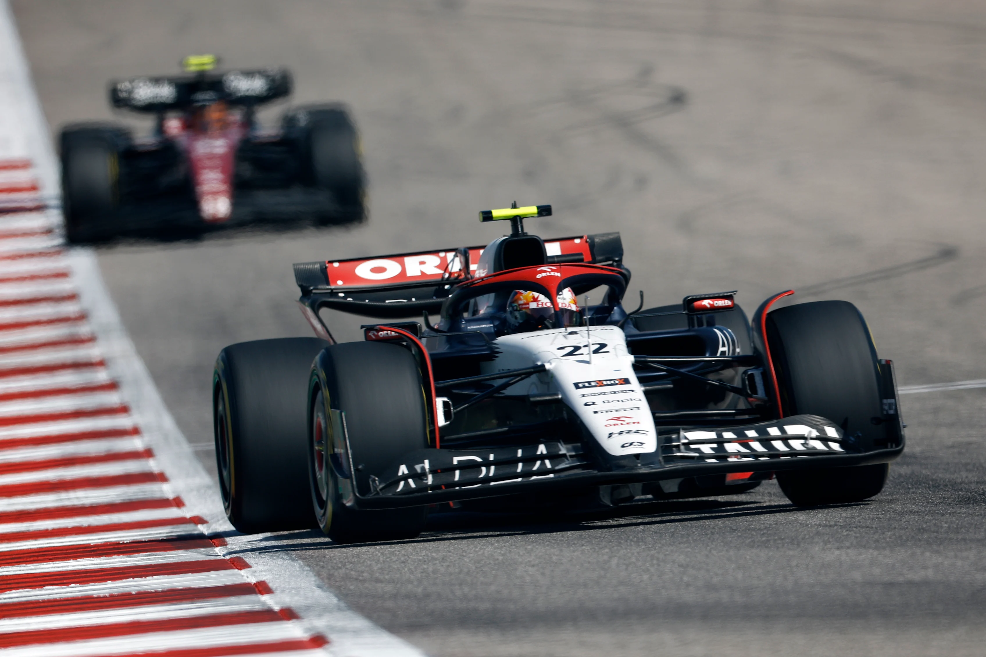 AUSTIN, TEXAS - OCTOBER 22: Yuki Tsunoda of Japan driving the (22) Scuderia AlphaTauri AT04 leads Zhou Guanyu of China driving the (24) Alfa Romeo F1 C43 Ferrari on track during the F1 Grand Prix of United States at Circuit of The Americas on October 22, 2023 in Austin, Texas. (Photo by Chris Graythen/Getty Images)