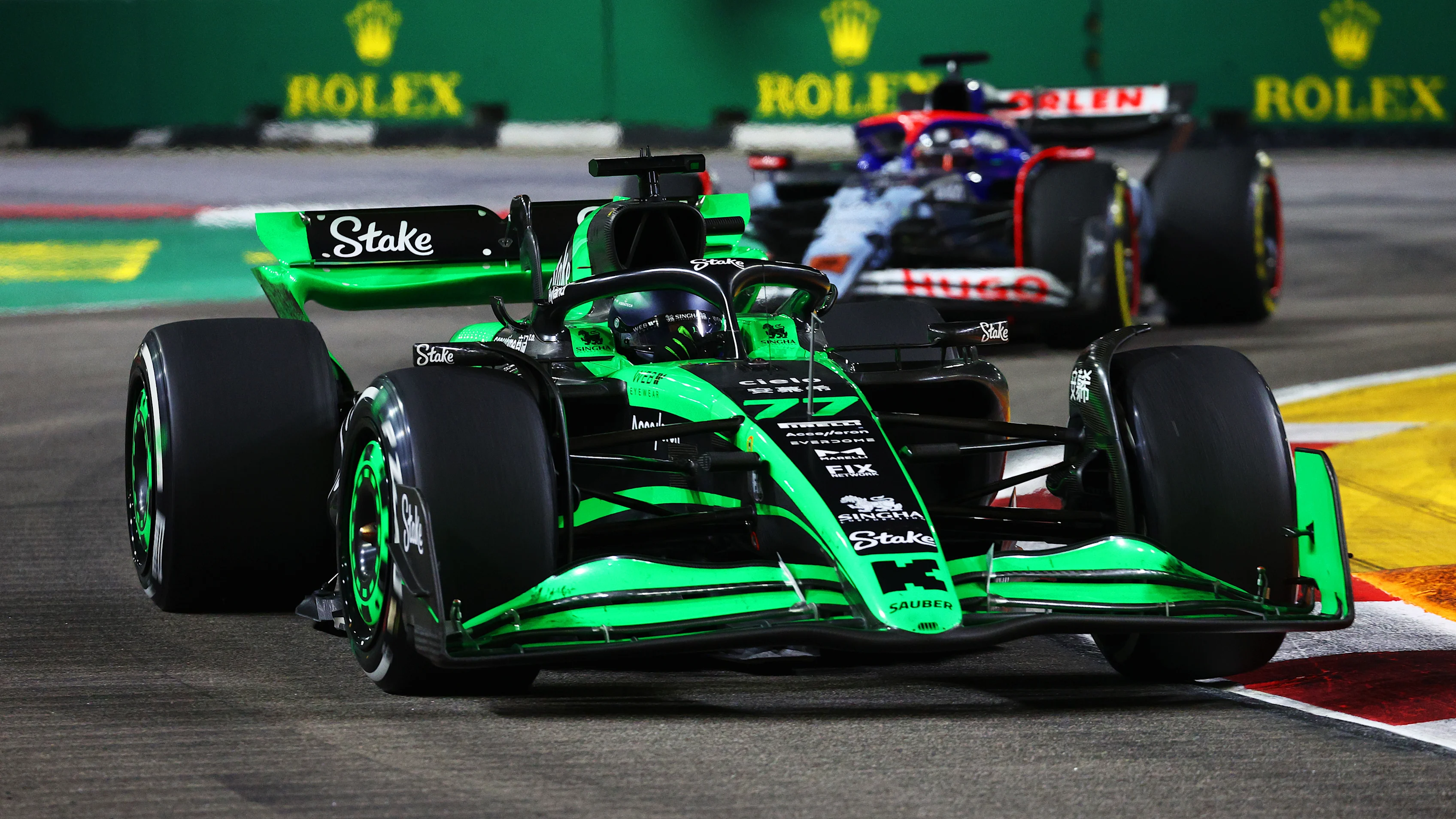 SEPTEMBER 22: Valtteri Bottas driving the (77) Kick Sauber C44 Ferrari leads Daniel Ricciardo driving the (3) Visa Cash App RB VCARB 01 on track during the F1 Grand Prix of Singapore. (Photo by Clive Rose - Formula 1/Formula 1 via Getty Images)