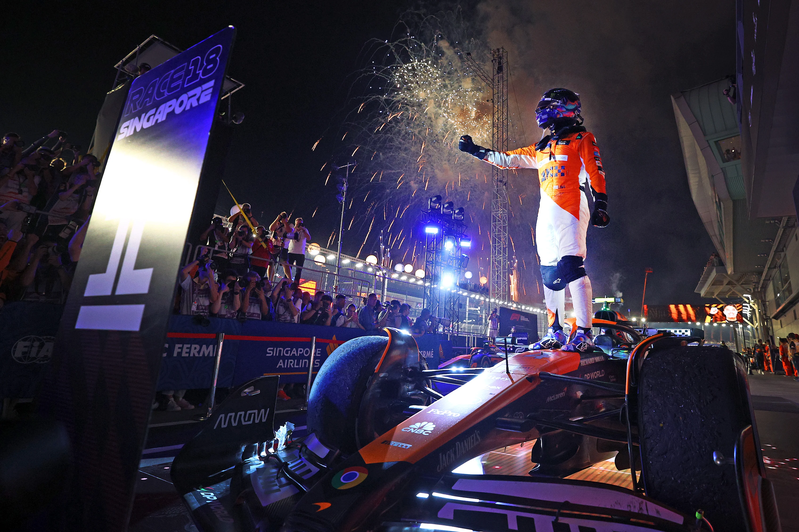 SINGAPORE, SINGAPORE - SEPTEMBER 22: Race winner Lando Norris of Great Britain and McLaren