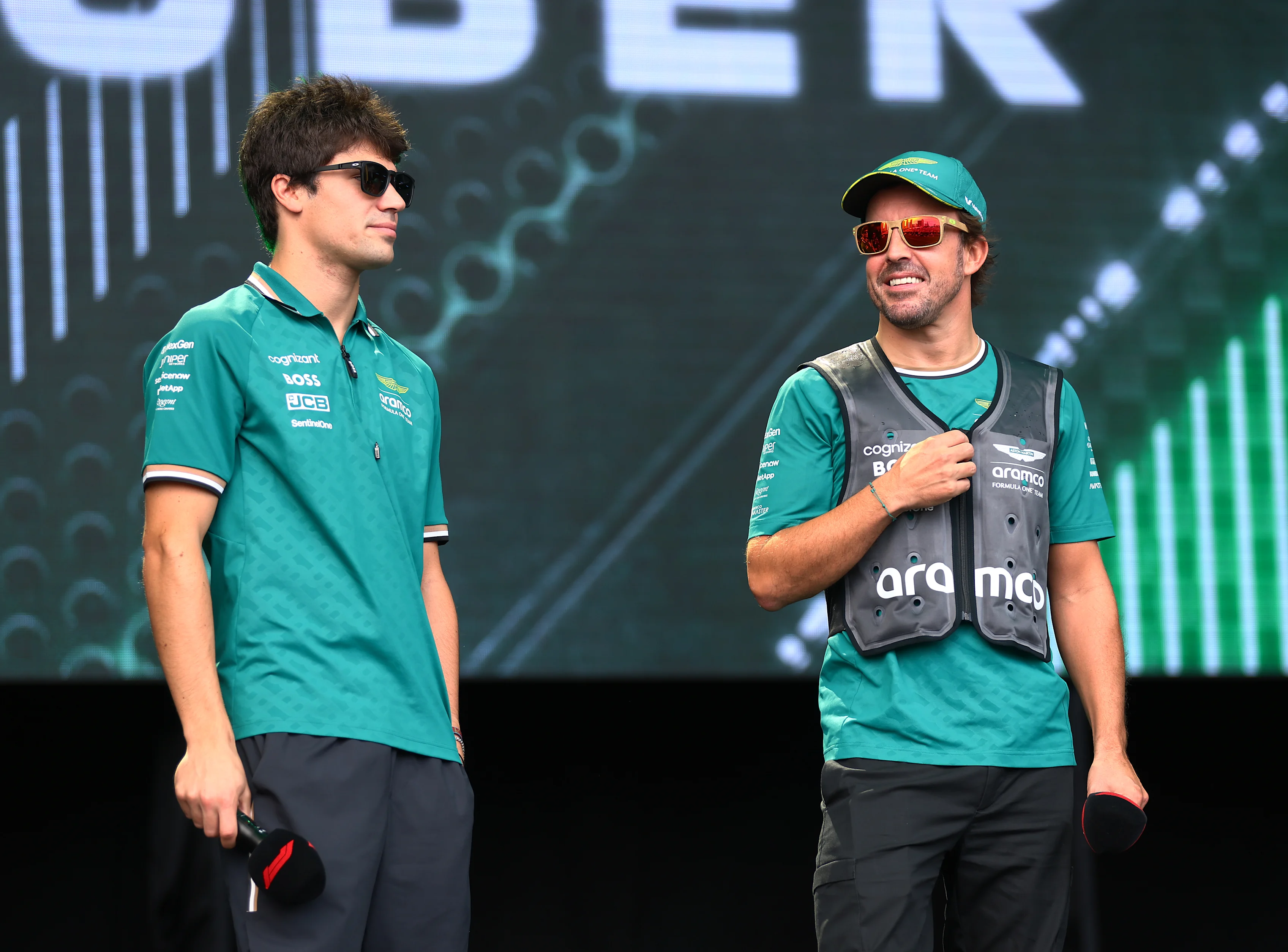 SINGAPORE, SINGAPORE - SEPTEMBER 20: Lance Stroll and Fernando Alonso talk to the crowd on the fan stage prior to practice ahead of the F1 Grand Prix of Singapore at Marina Bay Street Circuit. (Photo by Lars Baron - Formula 1/Formula 1 via Getty Images)