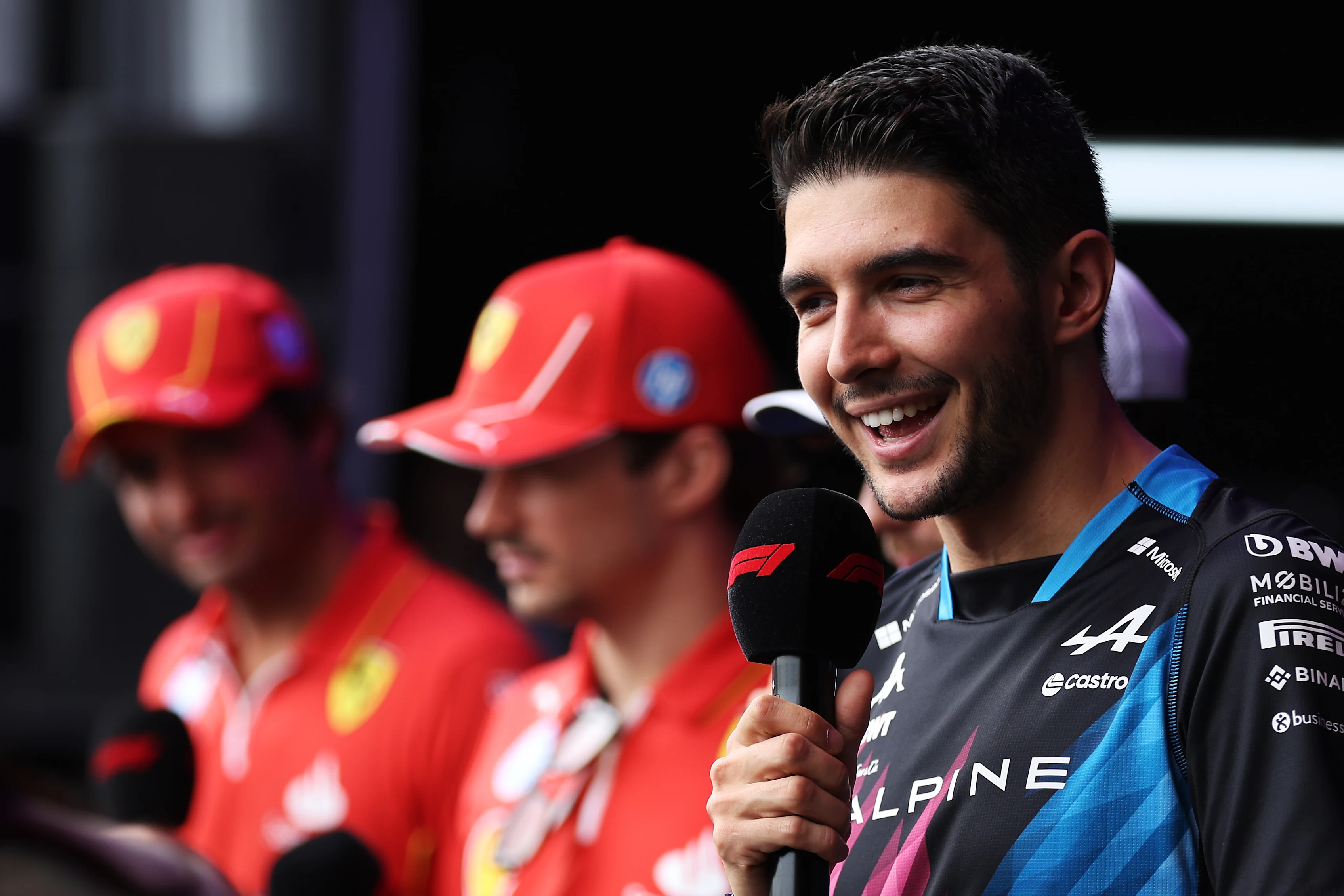 SINGAPORE, SINGAPORE - SEPTEMBER 21: Esteban Ocon of France and Alpine F1 talks to the crowd on the fan stage prior to final practice ahead of the F1 Grand Prix of Singapore at Marina Bay Street Circuit on September 21, 2024 in Singapore, Singapore. (Photo by Lars Baron - Formula 1/Formula 1 via Getty Images)