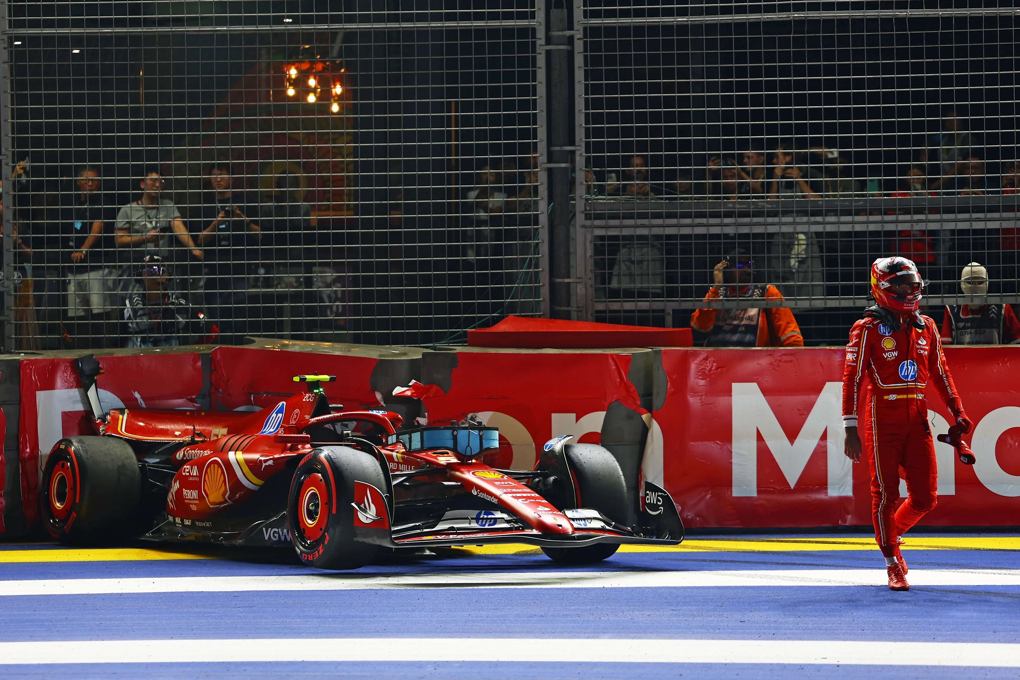 SINGAPORE, SINGAPORE - SEPTEMBER 21: Carlos Sainz of Spain and Ferrari walks from his car after