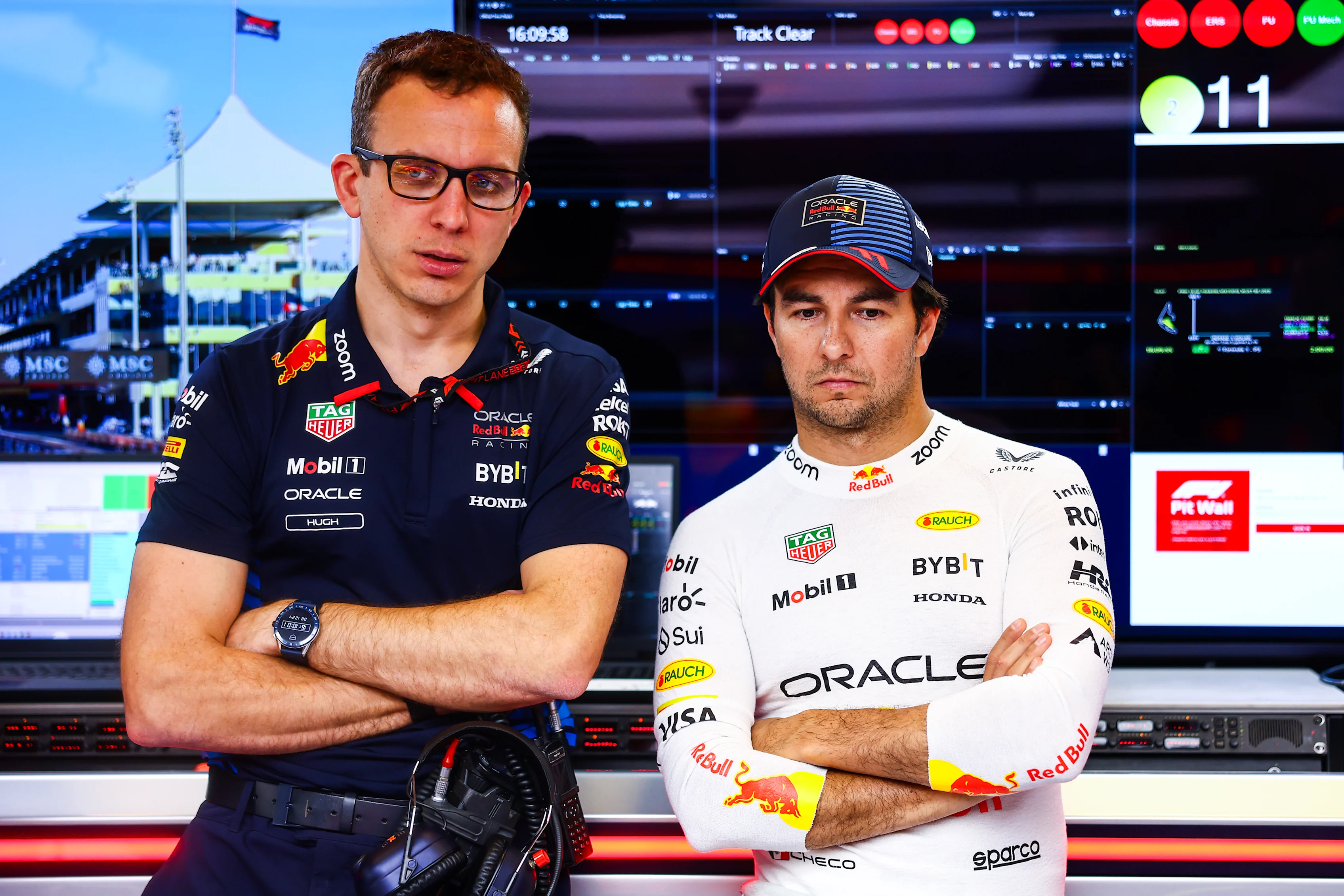 Sergio Perez of Mexico and Oracle Red Bull Racing and race engineer Hugh Bird look on in the garage prior to the F1 Grand Prix of Abu Dhabi at Yas Marina Circuit on December 08, 2024 in Abu Dhabi, United Arab Emirates. (Photo by Mark Thompson/Getty Images)