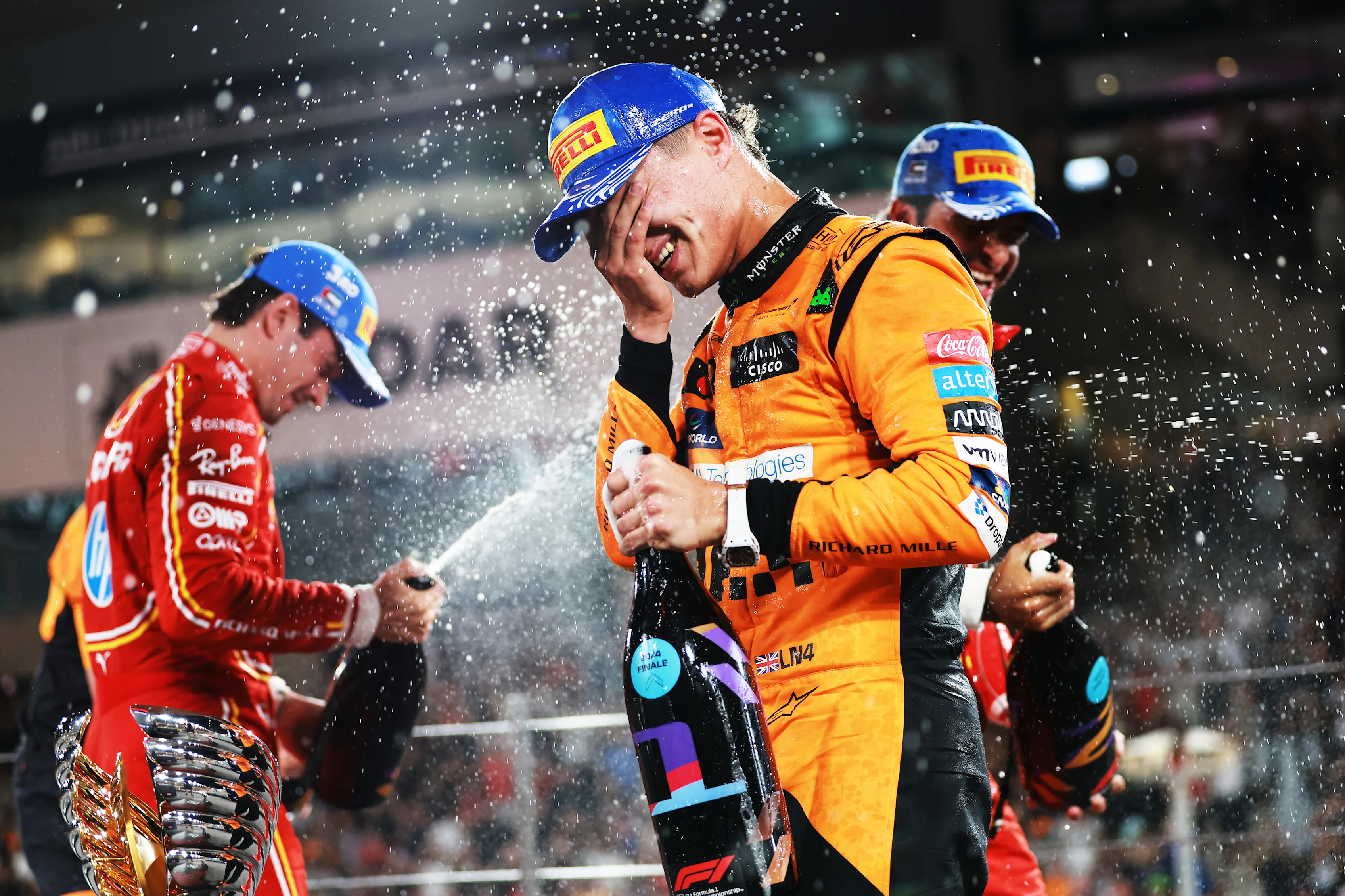 ABU DHABI, UNITED ARAB EMIRATES - DECEMBER 08: Race winner Lando Norris of Great Britain and McLaren celebrates on the podium during the F1 Grand Prix of Abu Dhabi at Yas Marina Circuit on December 08, 2024 in Abu Dhabi, United Arab Emirates. (Photo by Bryn Lennon - Formula 1/Formula 1 via Getty Images)