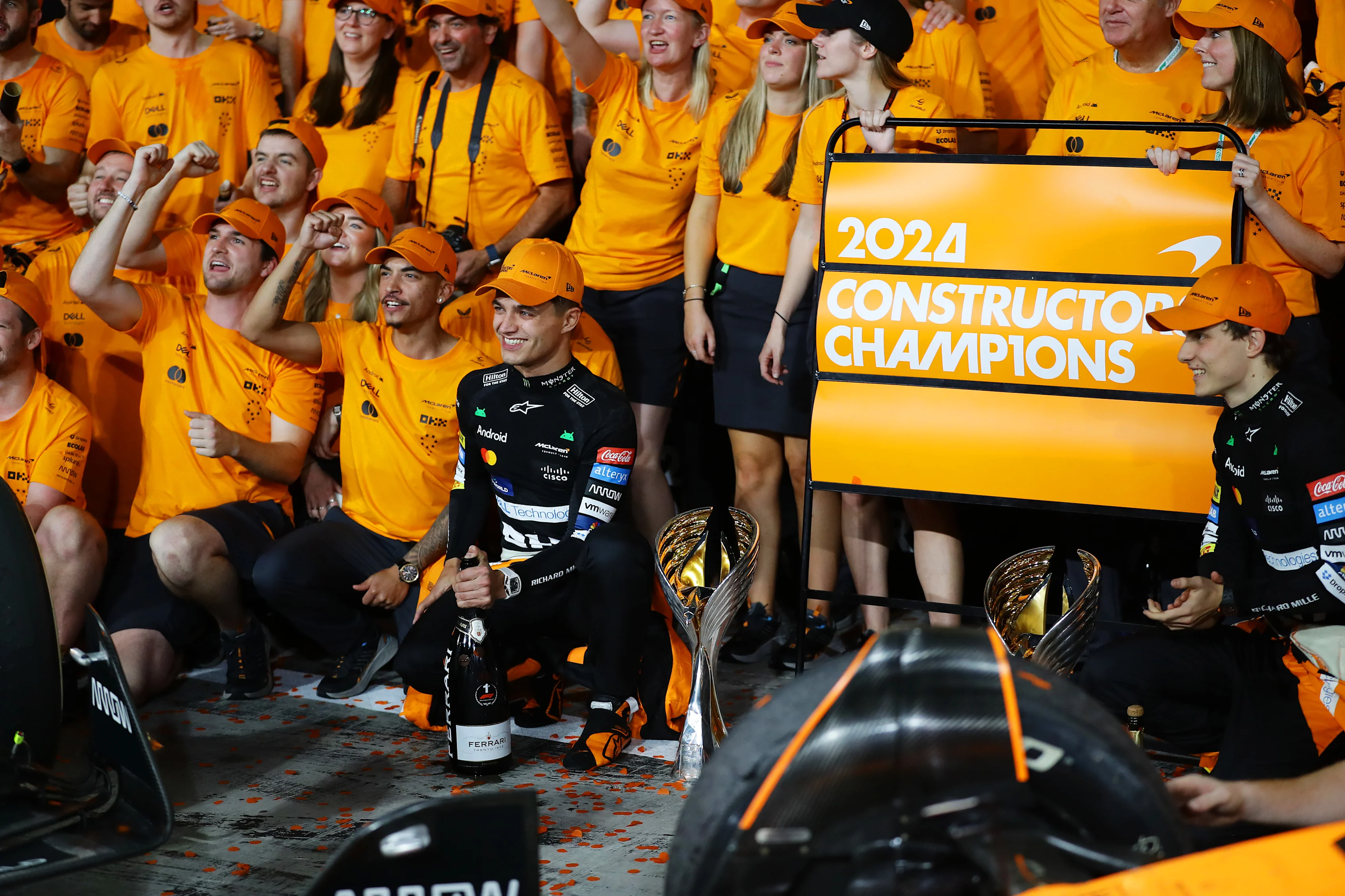 Lando Norris, Oscar Piastri and the McLaren team celebrate winning the 2024 F1 Constructors Championship after the Grand Prix of Abu Dhabi at Yas Marina Circuit on December 08, 2024 in Abu Dhabi, United Arab Emirates. (Photo by Joe Portlock/Getty Images)