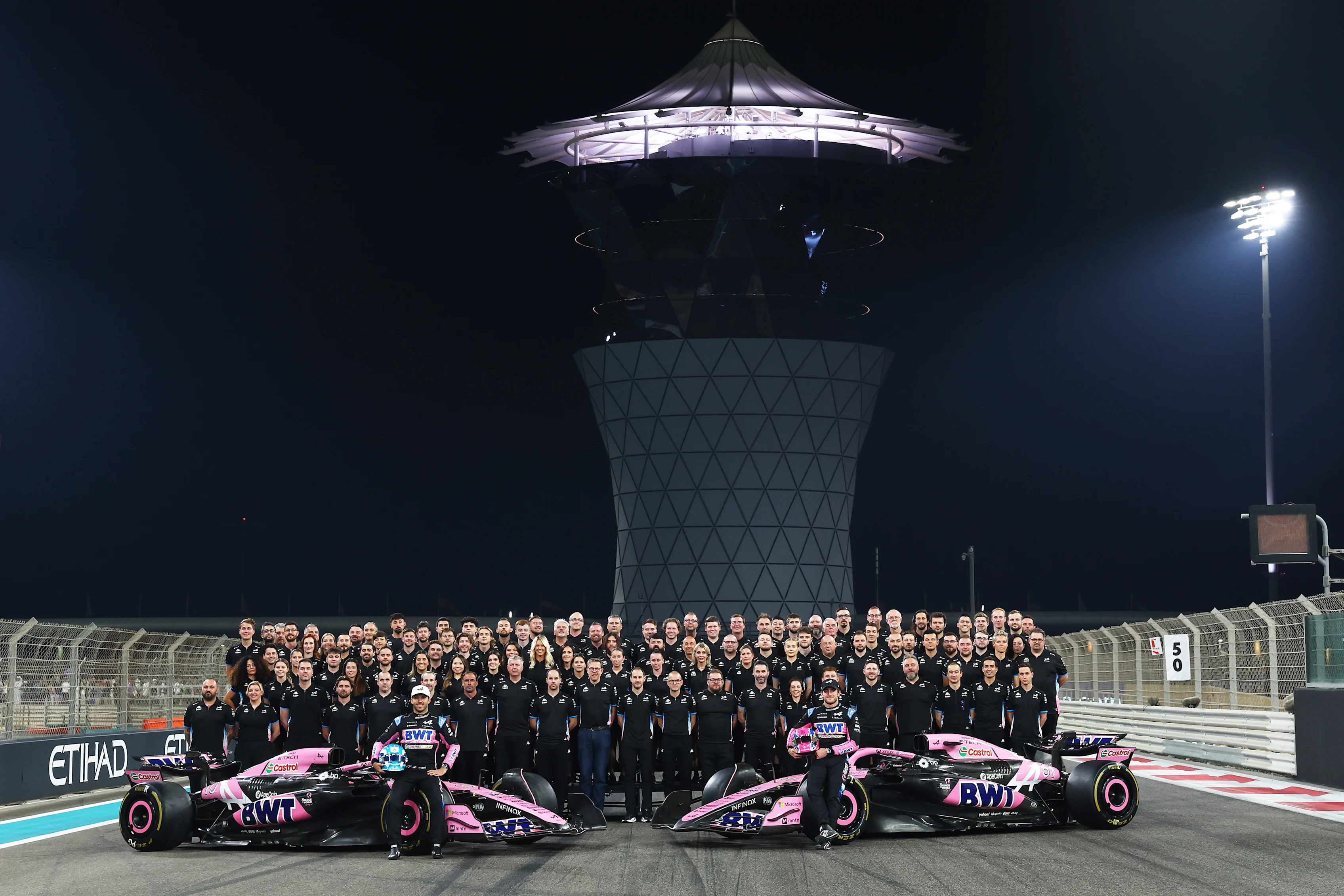 Pierre Gasly and Jack Doohan pose with their team after qualifying ahead of the F1 Grand Prix of Abu Dhabi at Yas Marina Circuit on December 07, 2024 in Abu Dhabi, United Arab Emirates. (Photo by Bryn Lennon - Formula 1/Formula 1 via Getty Images)