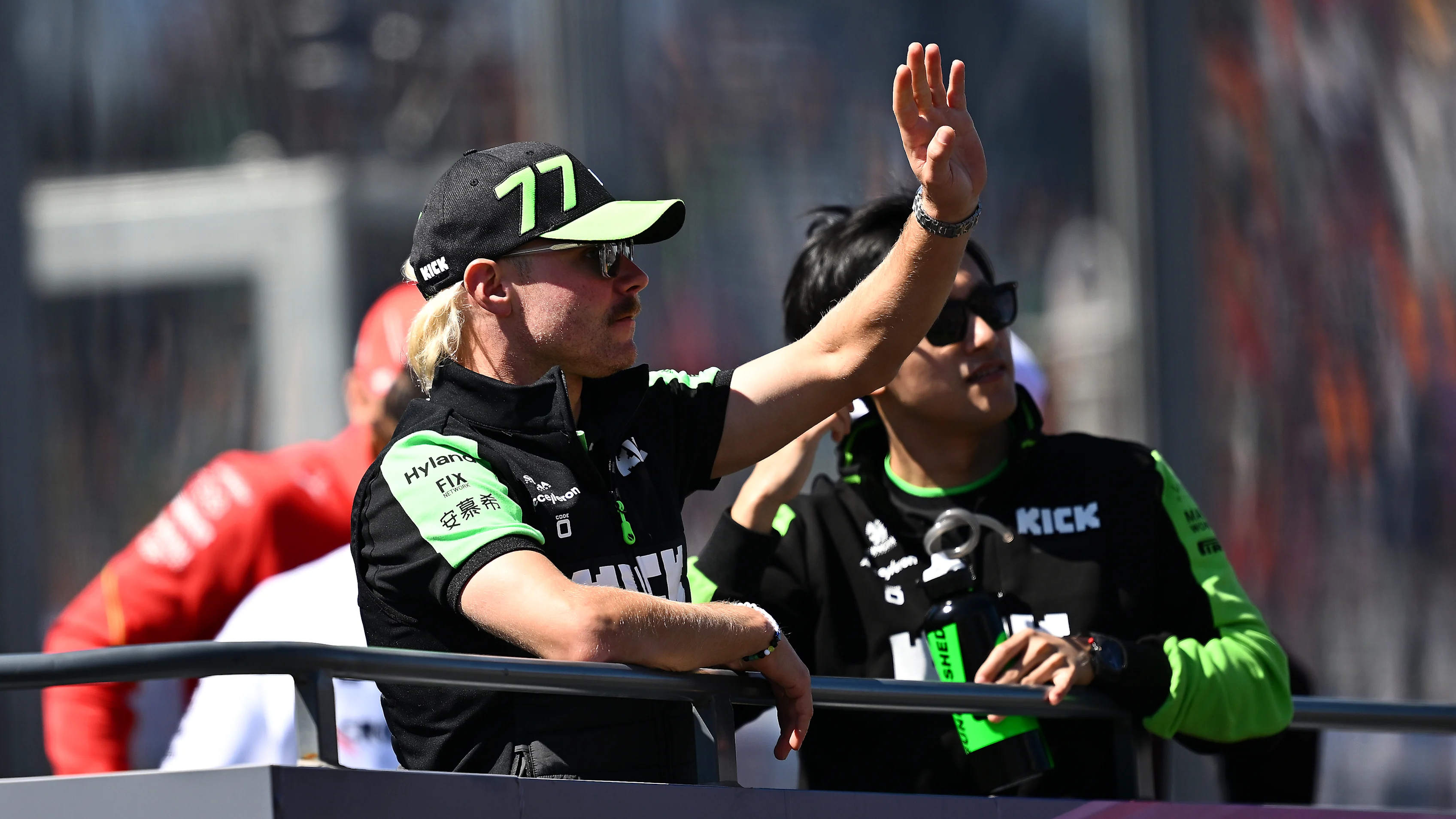 MELBOURNE, AUSTRALIA - MARCH 24: Zhou Guanyu of China and Stake F1 Team Kick Sauber and Valtteri Bottas of Finland and Stake F1 Team Kick Sauber wave to the crowd on the drivers parade prior to the F1 Grand Prix of Australia at Albert Park Circuit on March 24, 2024 in Melbourne, Australia. (Photo by Quinn Rooney - Formula 1/Formula 1 via Getty Images)