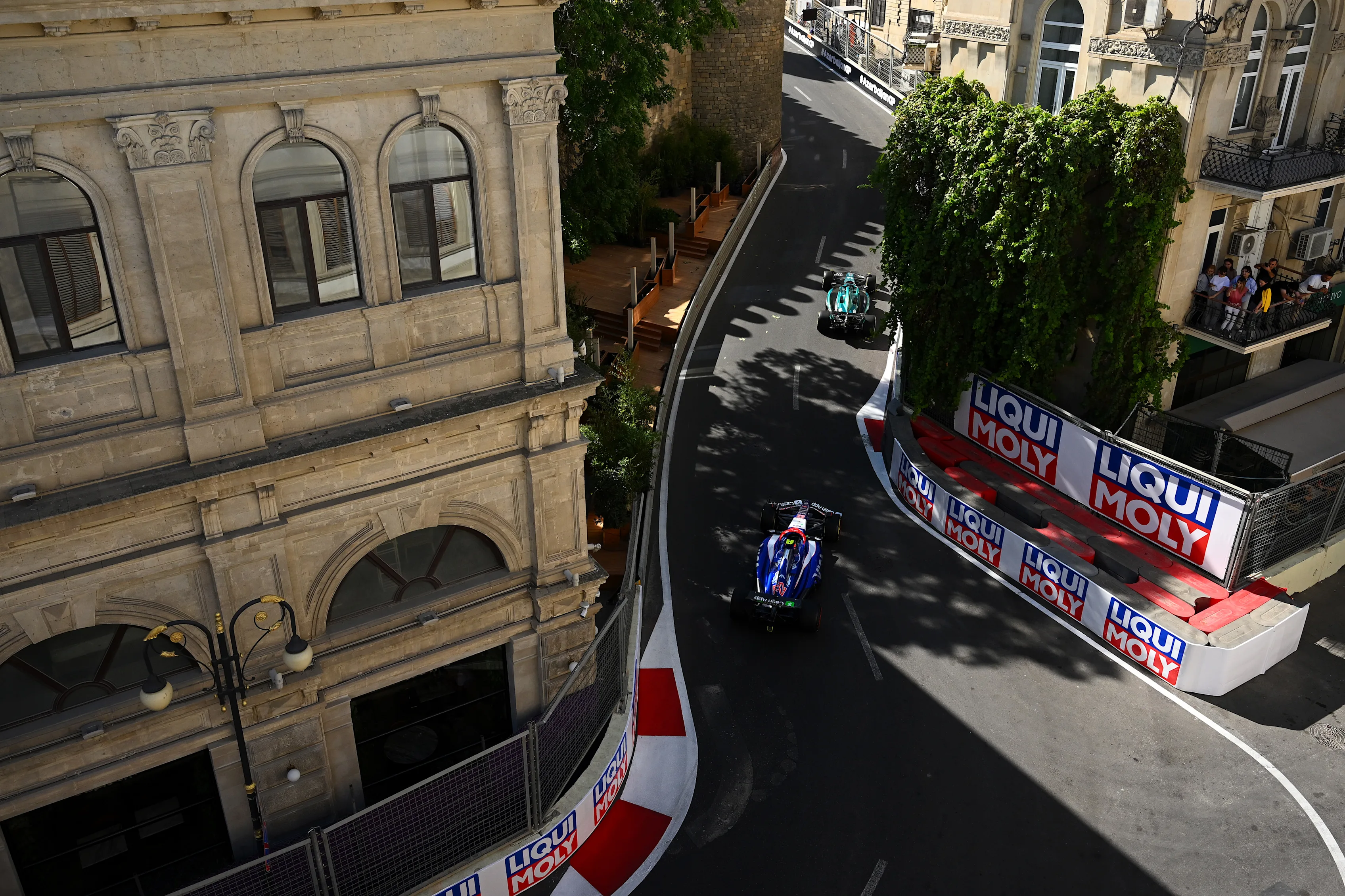 Modern speed meets 19th-century elegance as cars fly past Baku’s neoclassical façades. Swipe for more.