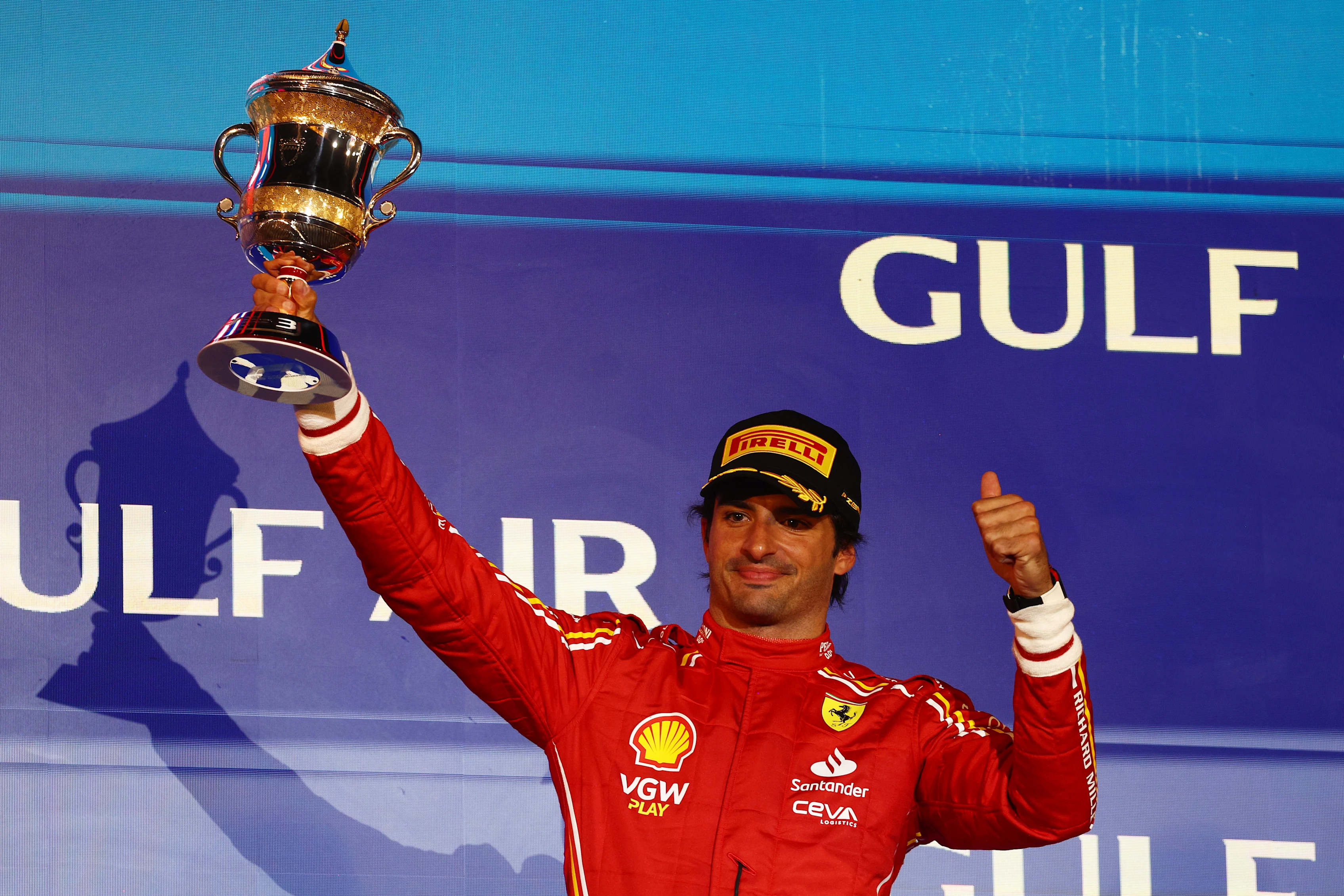 BAHRAIN, BAHRAIN - MARCH 02: Third placed Carlos Sainz of Spain and Ferrari celebrates on the podium during the F1 Grand Prix of Bahrain at Bahrain International Circuit on March 02, 2024 in Bahrain, Bahrain. (Photo by Clive Rose/Getty Images)