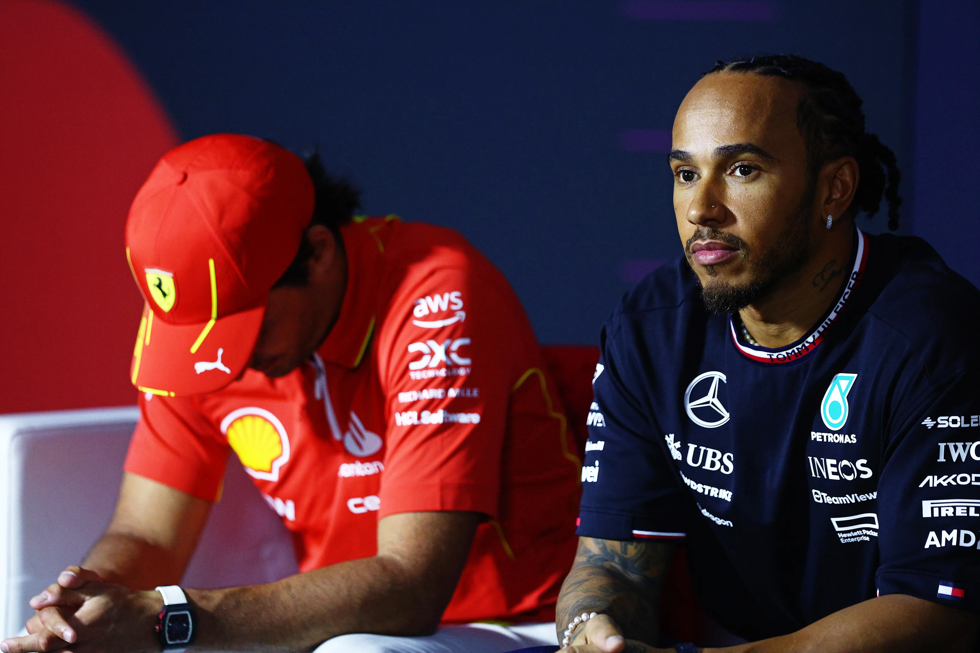 BAHRAIN, BAHRAIN - FEBRUARY 28: Carlos Sainz of Spain and Ferrari and Lewis Hamilton of Great Britain and Mercedes attend the Drivers Press Conference during previews ahead of the F1 Grand Prix of Bahrain at Bahrain International Circuit on February 28, 2024 in Bahrain, Bahrain. (Photo by Clive Rose/Getty Images)