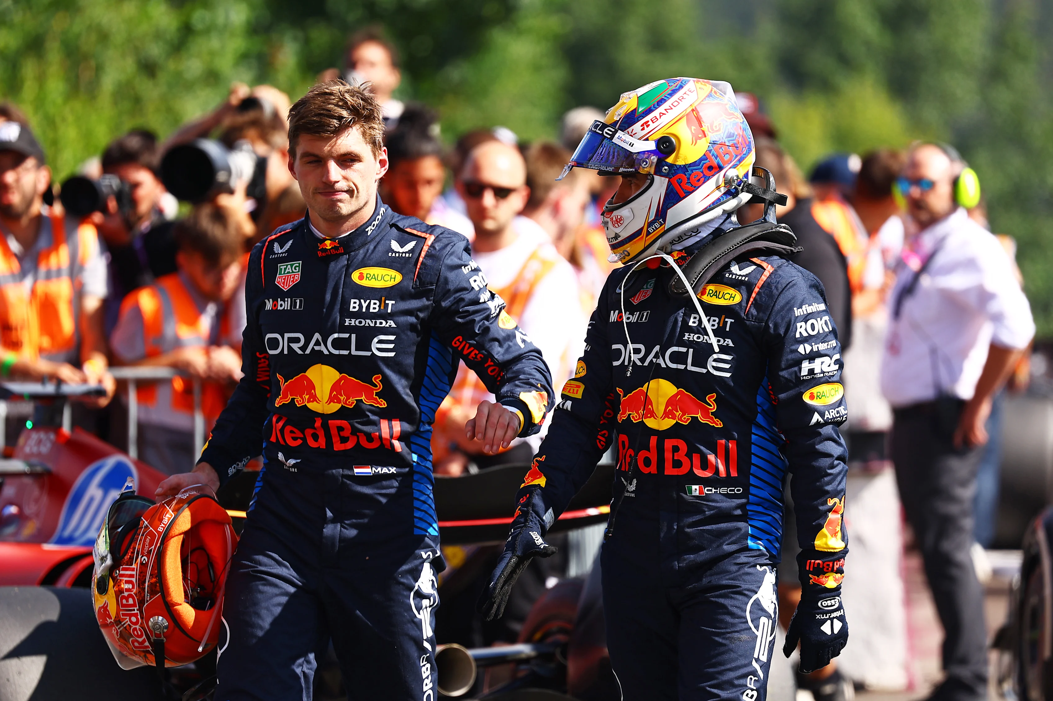 SPA, BELGIUM - JULY 28: 5th placed Max Verstappen of the Netherlands and Oracle Red Bull Racing and 8th placed Sergio Perez of Mexico and Oracle Red Bull Racing talk in parc ferme during the F1 Grand Prix of Belgium at Circuit de Spa-Francorchamps on July 28, 2024 in Spa, Belgium. (Photo by Mark Thompson/Getty Images)