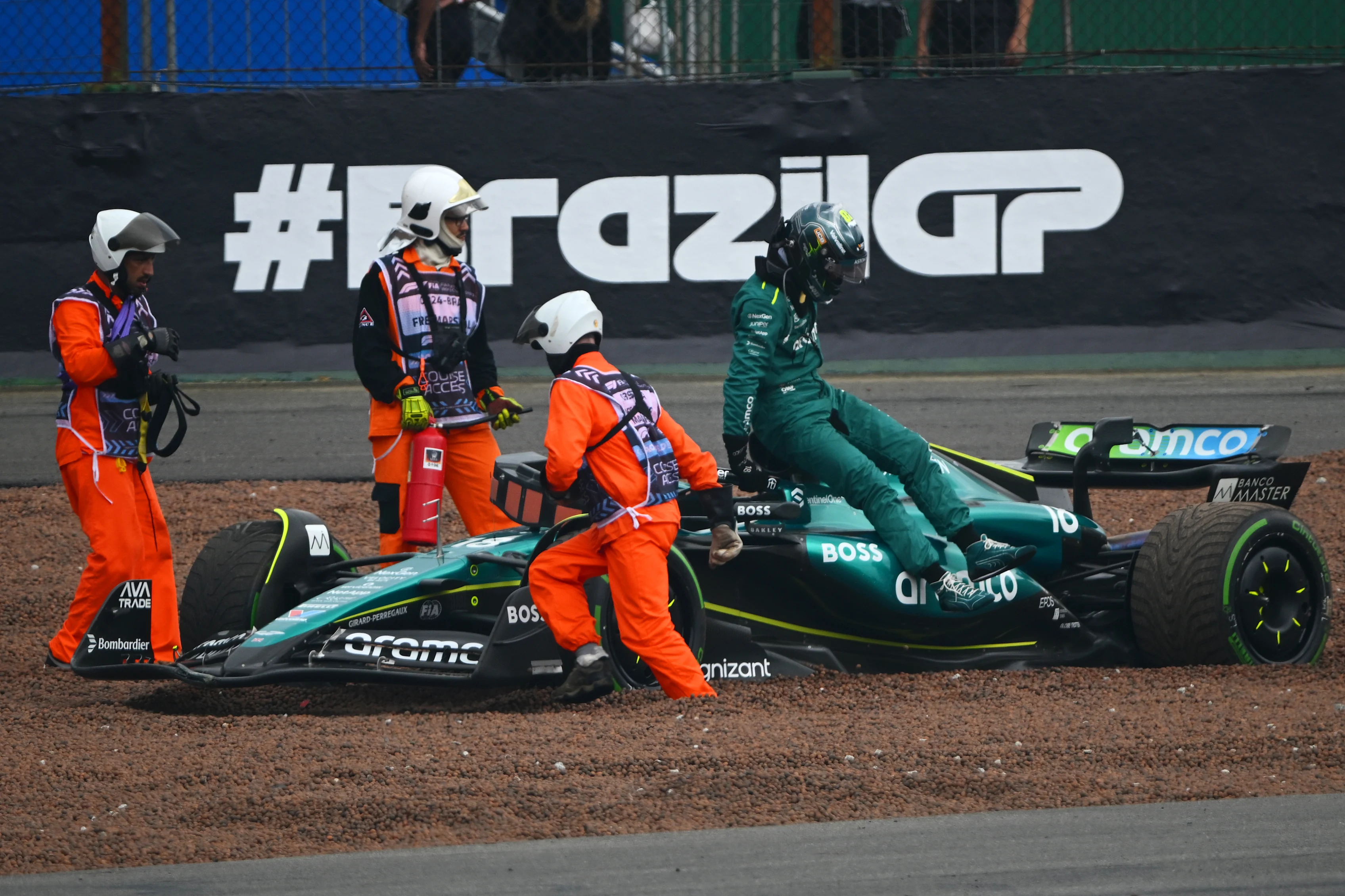 SAO PAULO, BRAZIL - NOVEMBER 03: Lance Stroll of Aston Martin F1 Team climbs out of his car after crashing during the F1 Grand Prix of Brazil at Autodromo Jose Carlos Pace on November 03, 2024 in Sao Paulo, Brazil. (Photo by Clive Mason/Getty Images)