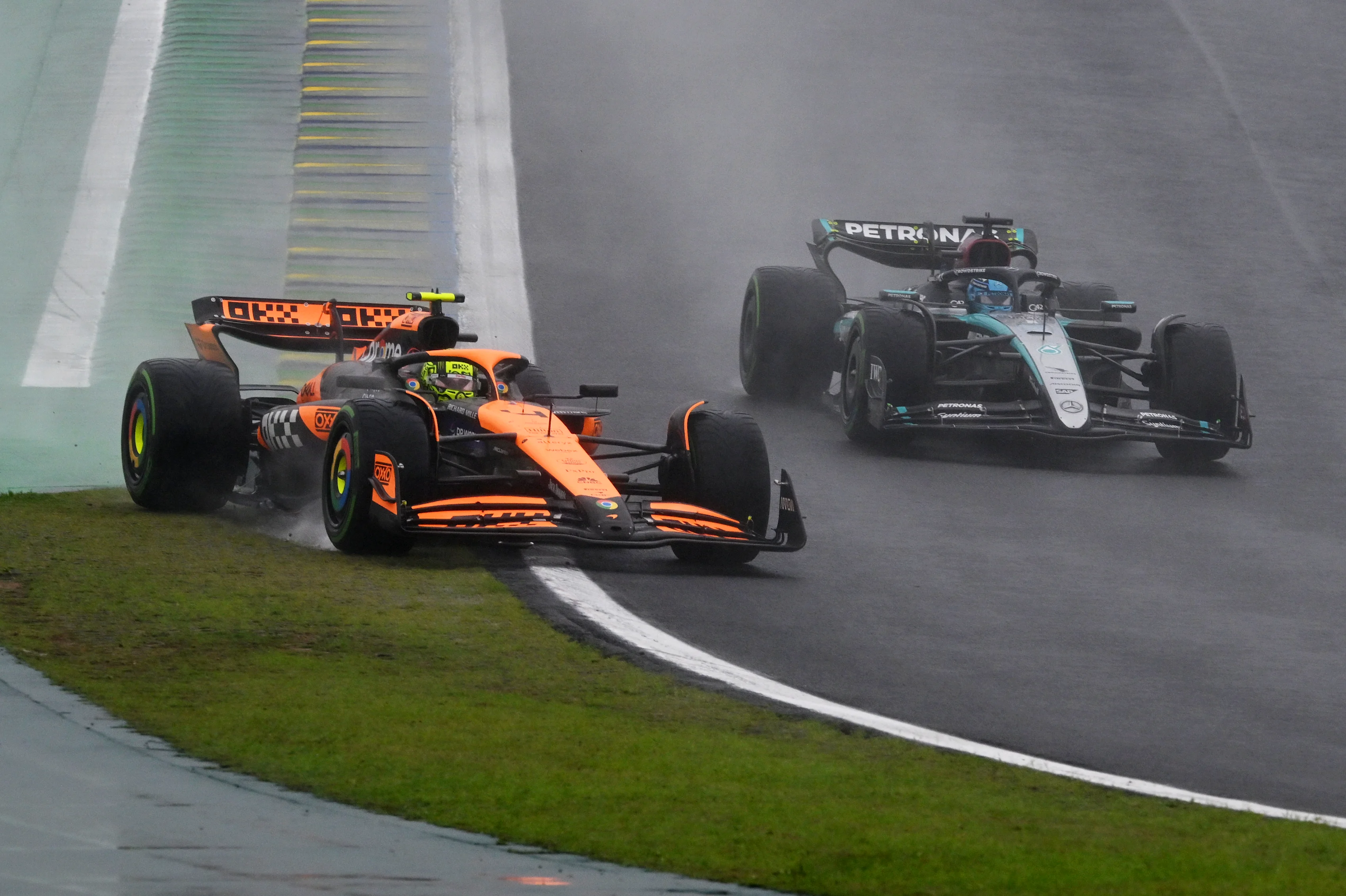 SAO PAULO, BRAZIL - NOVEMBER 03: Lando Norris of Great Britain driving the (4) McLaren MCL38 Mercedes rejoins the track ahead of George Russell of Great Britain driving the (63) Mercedes AMG Petronas F1 Team W15 during the F1 Grand Prix of Brazil at Autodromo Jose Carlos Pace on November 03, 2024 in Sao Paulo, Brazil. (Photo by Clive Mason/Getty Images)
