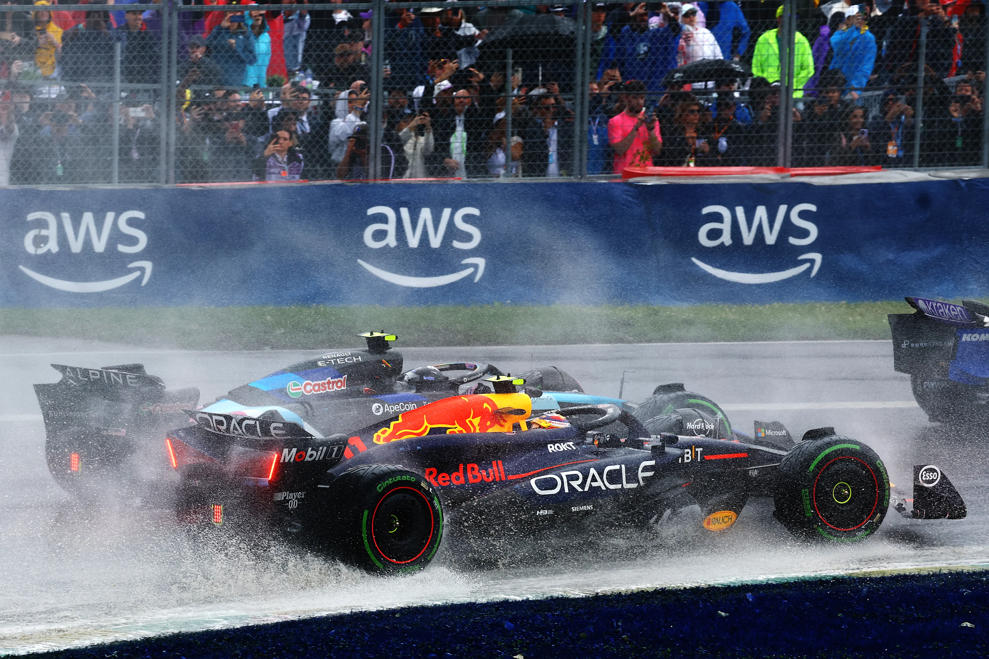 MONTREAL, QUEBEC - JUNE 09: Sergio Perez of Mexico driving the (11) Oracle Red Bull Racing RB20 battles for position with Esteban Ocon of France driving the (31) Alpine F1 A524 Renault on track during the F1 Grand Prix of Canada at Circuit Gilles Villeneuve on June 09, 2024 in Montreal, Quebec. (Photo by Mark Thompson/Getty Images)