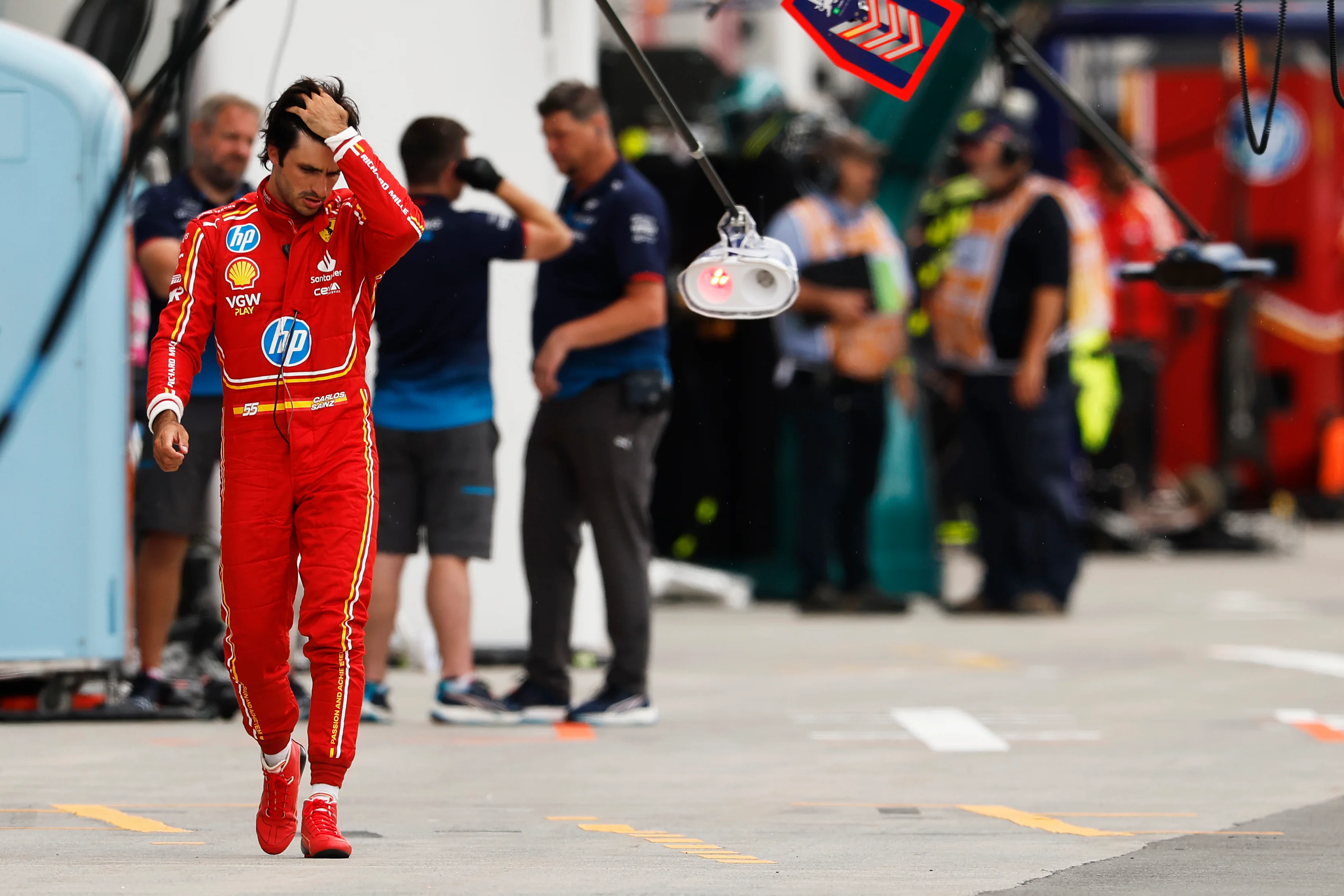MONTREAL, QUEBEC - JUNE 08: 12th placed qualifier Carlos Sainz of Spain and Ferrari walks in the Pitlane during qualifying ahead of the F1 Grand Prix of Canada at Circuit Gilles Villeneuve on June 08, 2024 in Montreal, Quebec. (Photo by Chris Graythen/Getty Images)
