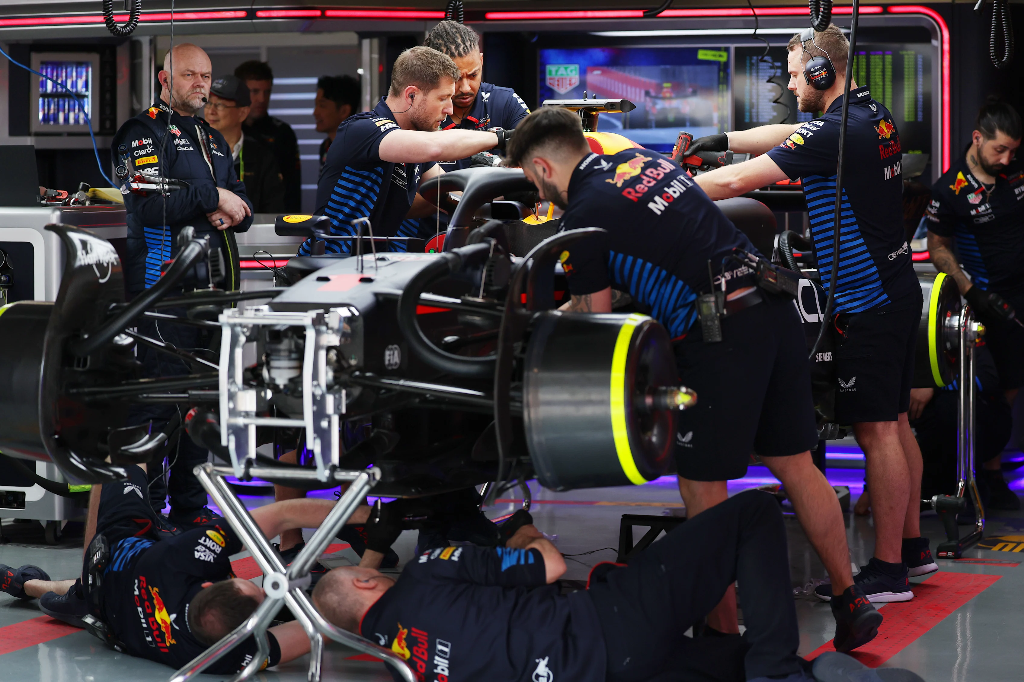 SHANGHAI, CHINA - APRIL 19: Oracle Red Bull Racing mechanics work in the garage during practice of