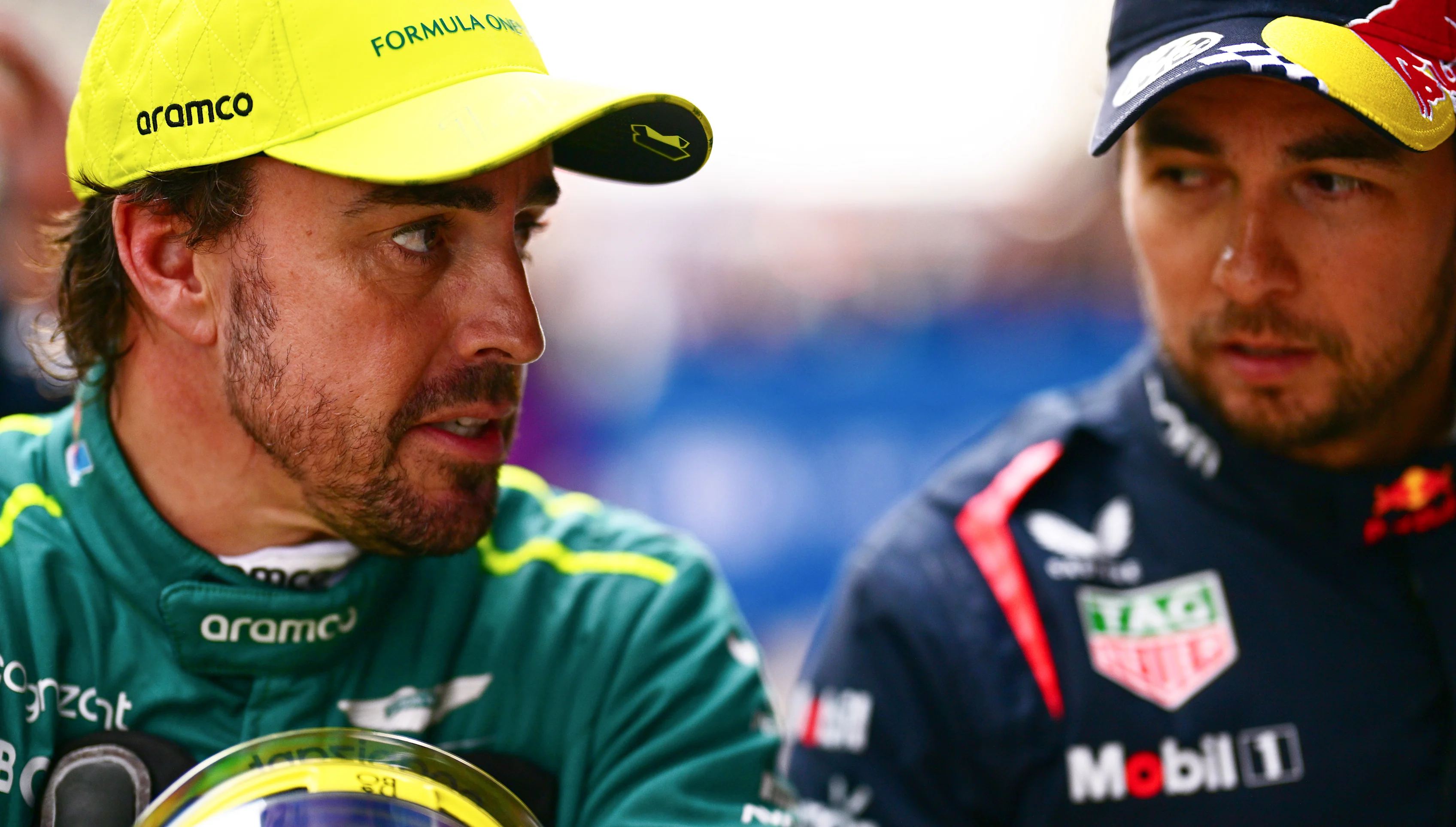 SHANGHAI, CHINA - APRIL 20: Third placed qualifier Fernando Alonso of Spain and Aston Martin F1 Team and Second placed qualifier Sergio Perez of Mexico and Oracle Red Bull Racing talk in parc ferme after qualifying ahead of the F1 Grand Prix of China at Shanghai International Circuit on April 20, 2024 in Shanghai, China. (Photo by Mario Renzi - Formula 1/Formula 1 via Getty Images)