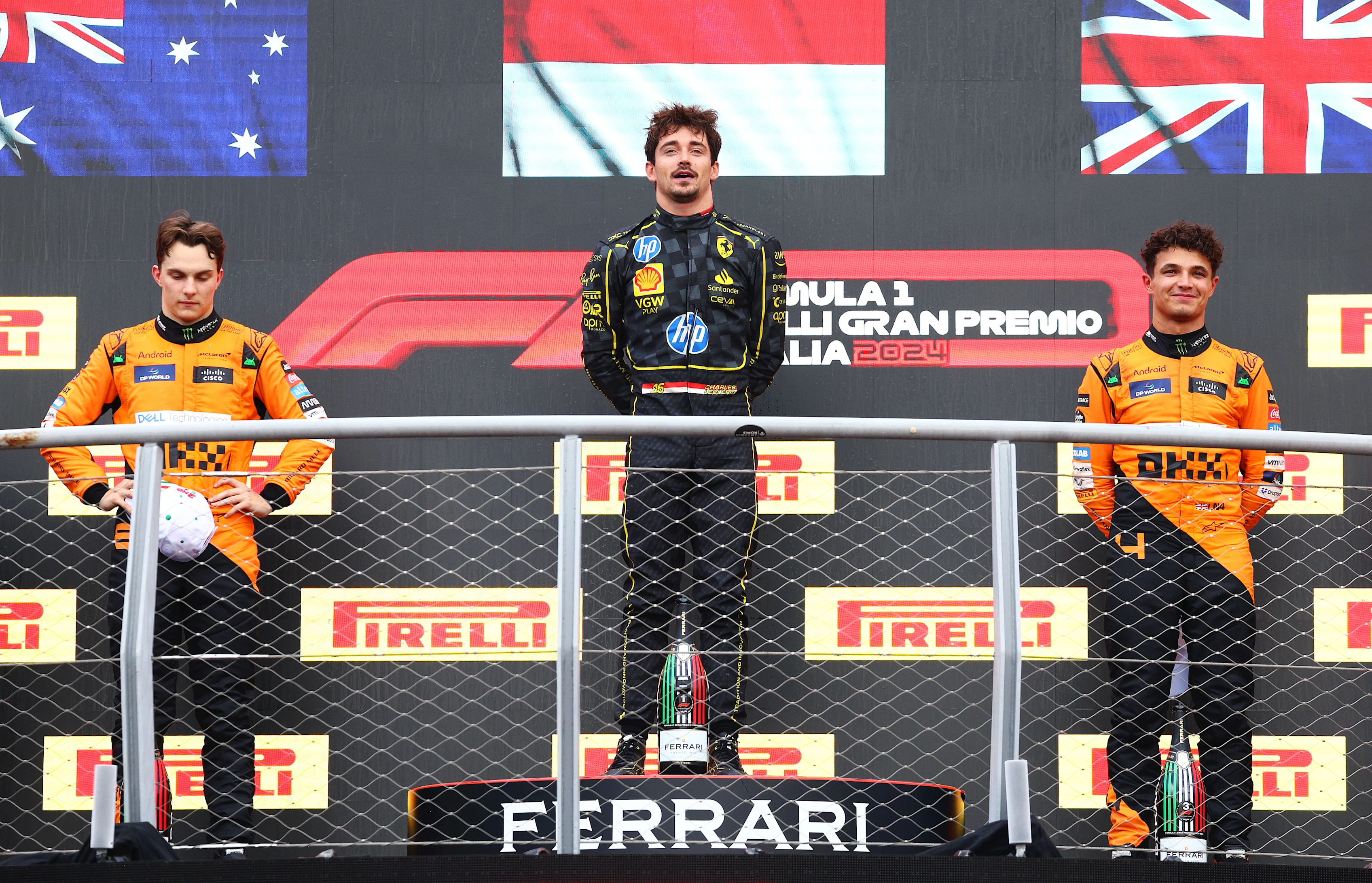 MONZA, ITALY - SEPTEMBER 01: Race winner Charles Leclerc of Monaco and Ferrari, with Second placed Oscar Piastri of Australia and McLaren and Third placed Lando Norris of Great Britain and McLaren, on the podium during the F1 Grand Prix of Italy at Autodromo Nazionale Monza on September 01, 2024 in Monza, Italy. (Photo by Clive Rose/Getty Images)