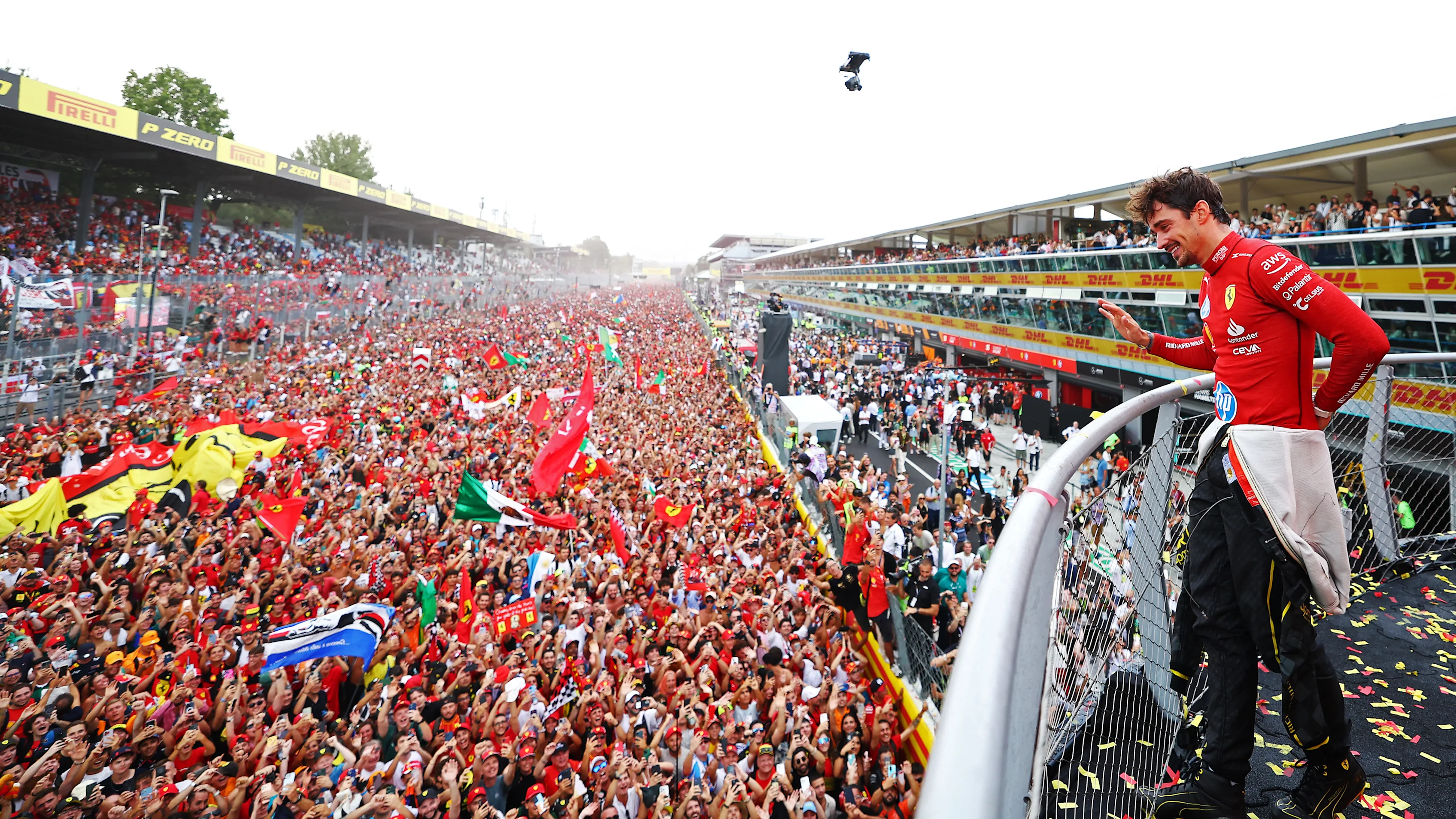 MONZA, ITALY - SEPTEMBER 01: Race winner Charles Leclerc of Monaco and Ferrari waves to fans from the podium during the F1 Grand Prix of Italy at Autodromo Nazionale Monza on September 01, 2024 in Monza, Italy. (Photo by Bryn Lennon - Formula 1/Formula 1 via Getty Images)