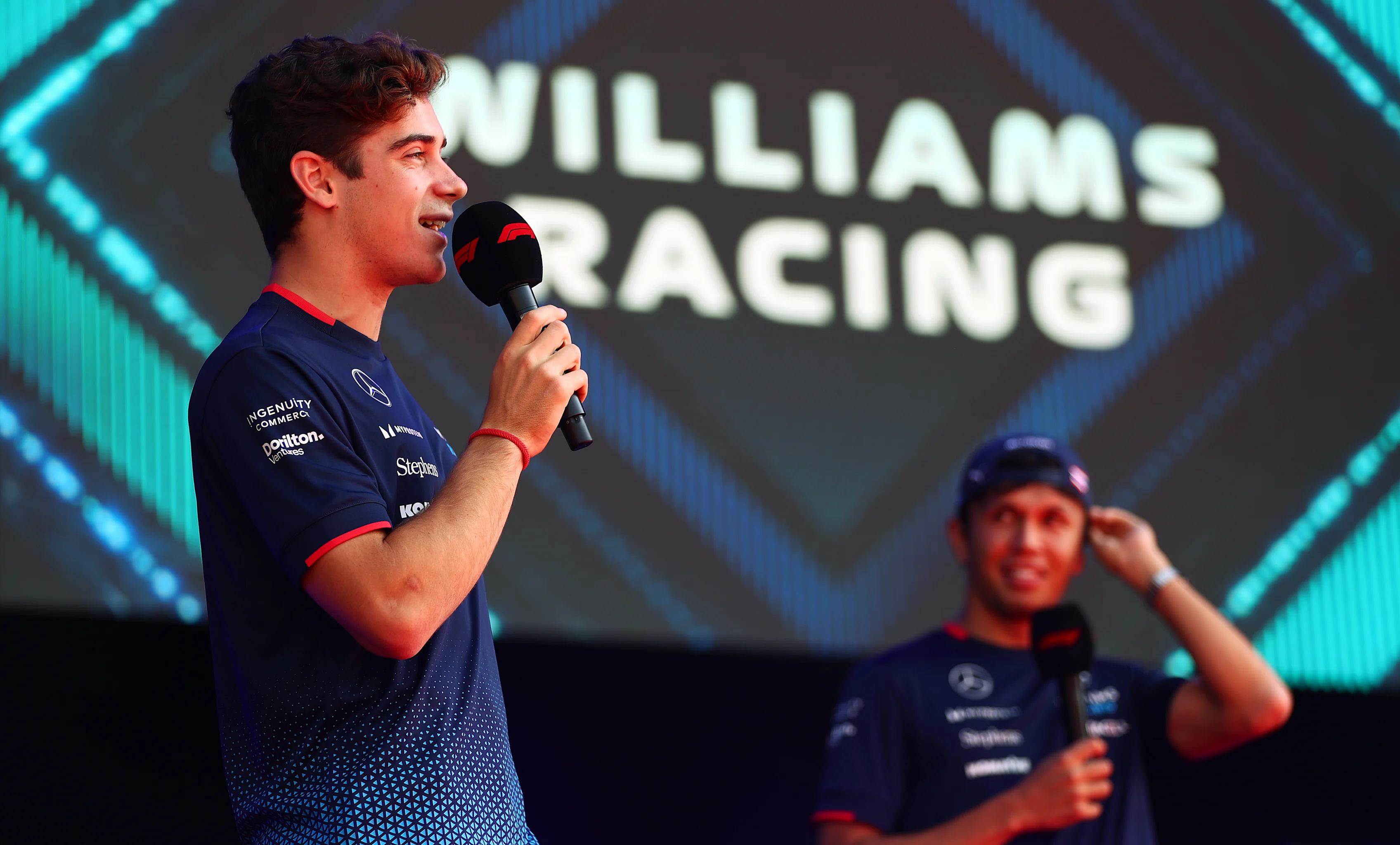 MONZA, ITALY - AUGUST 30: Franco Colapinto of Argentina and Williams and Alexander Albon of Thailand and Williams, on stage during the fan forum prior to practice ahead of the Grand Prix of Italy. (Photo by Peter Fox - Formula 1/Formula 1 via Getty Images)