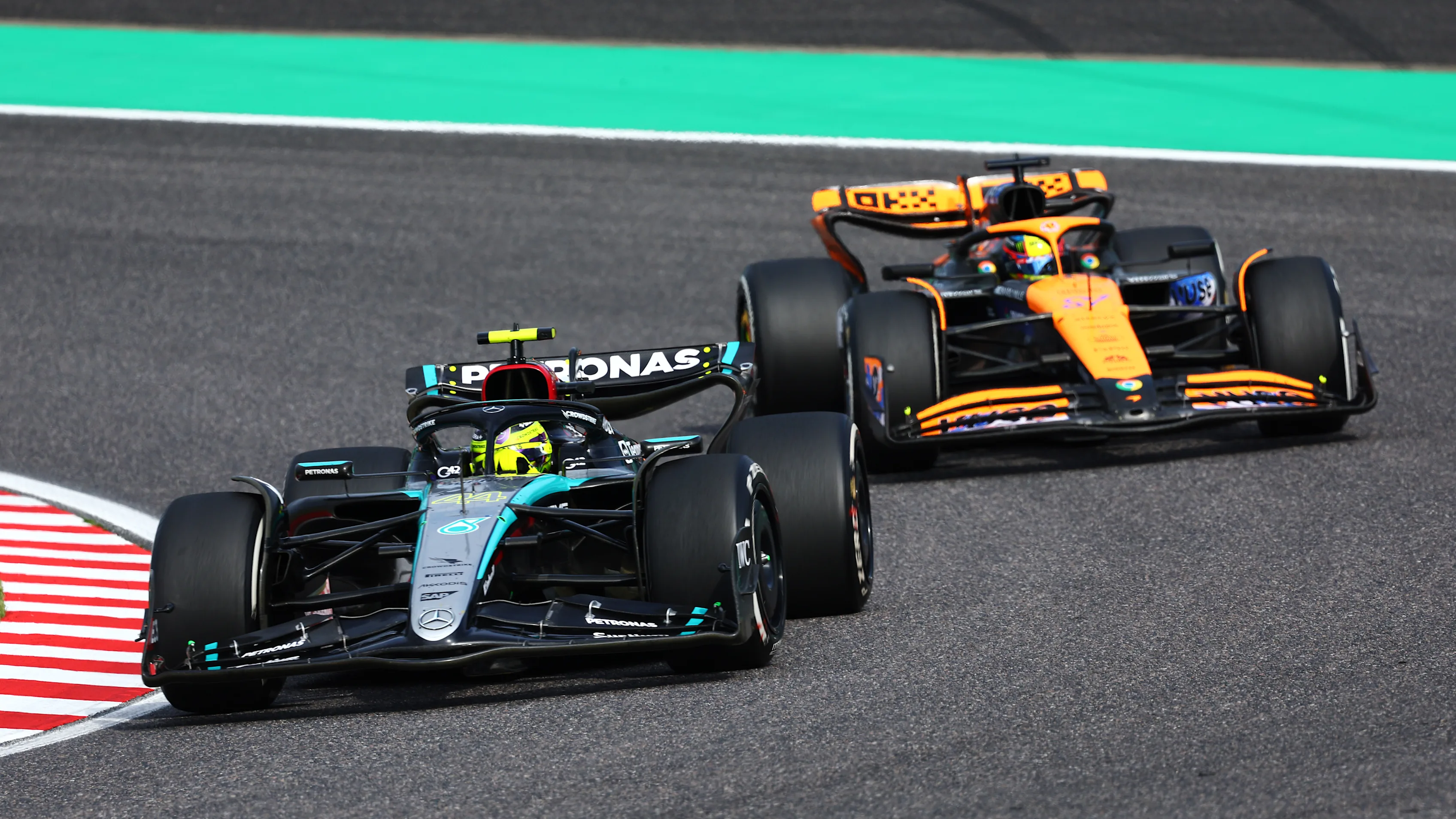 SUZUKA, JAPAN - APRIL 07: Lewis Hamilton of Great Britain driving the (44) Mercedes AMG Petronas F1 Team W15 leads Oscar Piastri of Australia driving the (81) McLaren MCL38 Mercedes during the F1 Grand Prix of Japan at Suzuka International Racing Course on April 07, 2024 in Suzuka, Japan. (Photo by Clive Rose - Formula 1/Formula 1 via Getty Images)