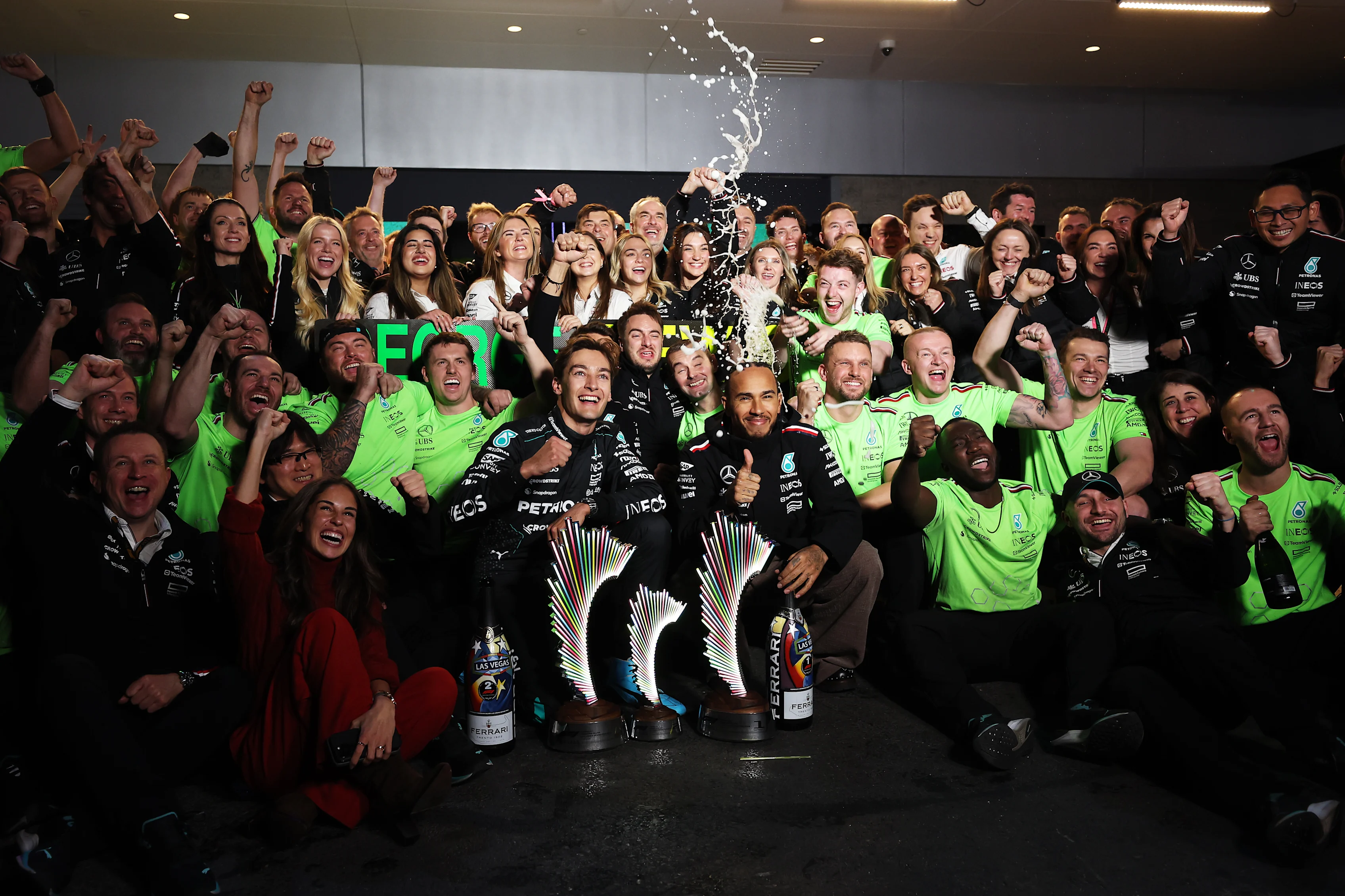 LAS VEGAS, NEVADA - NOVEMBER 23: Race winner George Russell of Great Britain and Mercedes and Second placed Lewis Hamilton of Great Britain and Mercedes celebrate with their team in the Pitlane after the F1 Grand Prix of Las Vegas at Las Vegas Strip Circuit on November 23, 2024 in Las Vegas, Nevada. (Photo by Meg Oliphant - Formula 1/Formula 1 via Getty Images)