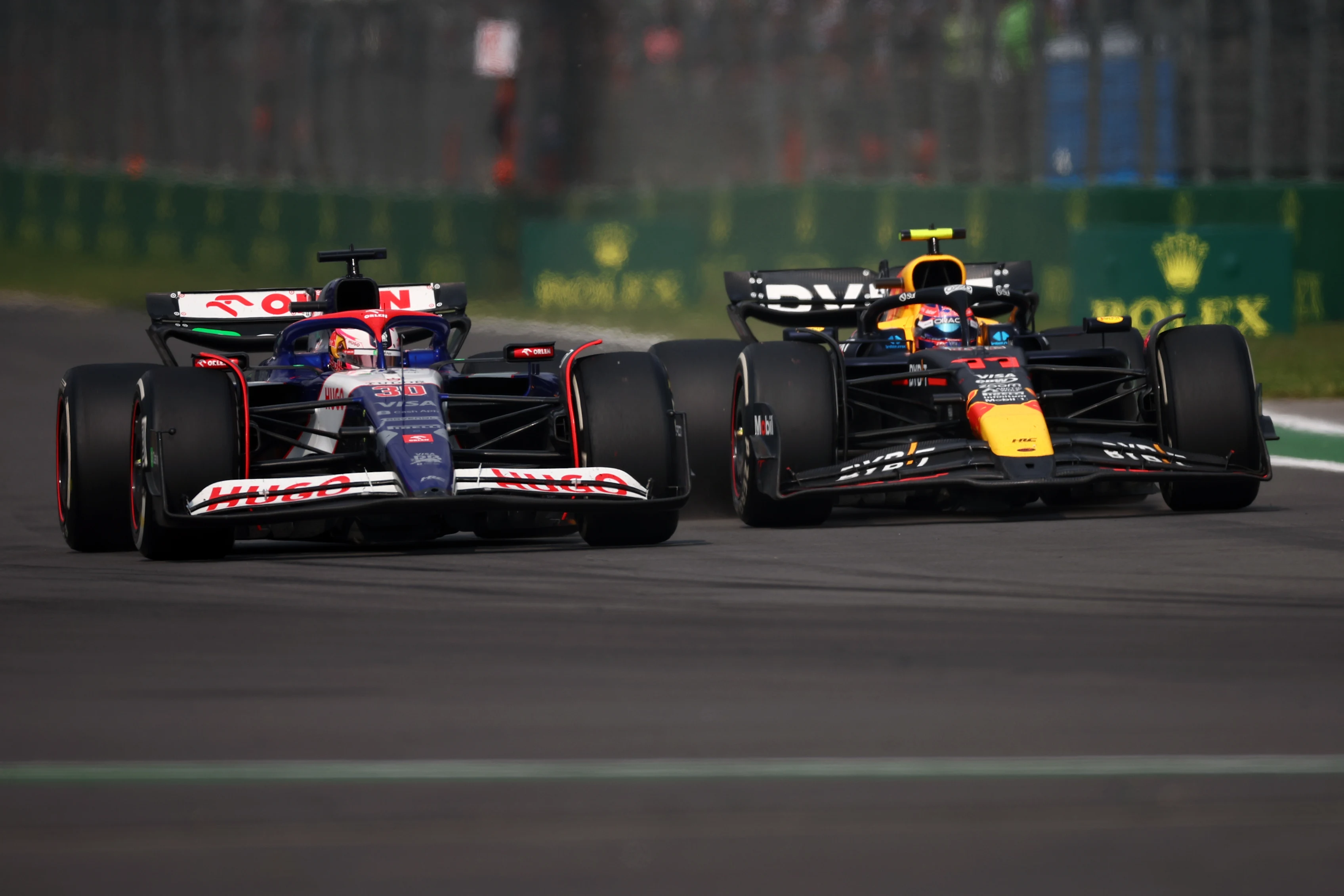 Liam Lawson and Sergio Perez of Mexico battle for position during the F1 Grand Prix of Mexico at Autodromo Hermanos Rodriguez on October 27, 2024 in Mexico City, Mexico. (Photo by Jared C. Tilton/Getty Images)