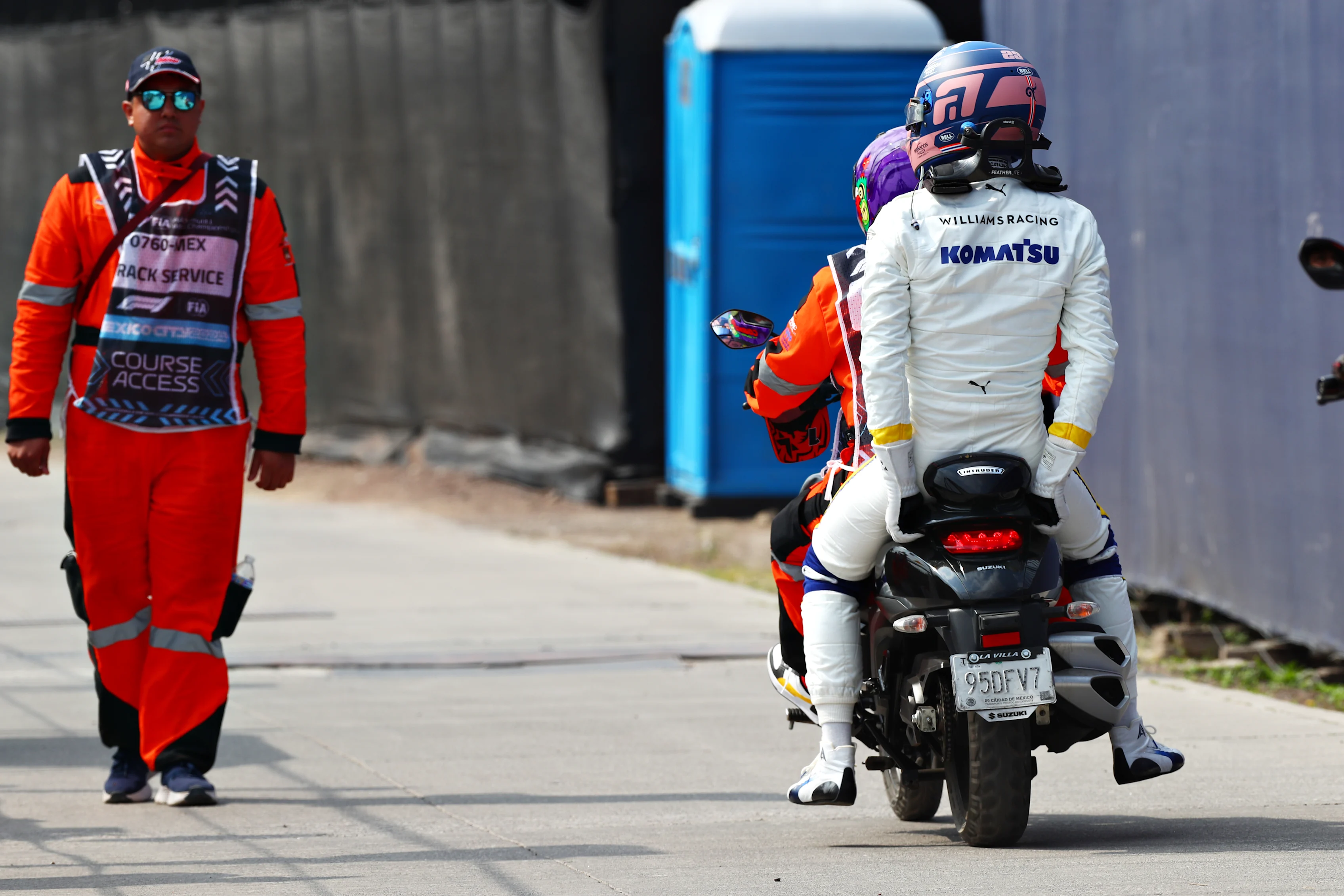 MEXICO CITY, MEXICO - OCTOBER 27: Alexander Albon of Thailand and Williams takes a ride on a bike after crashing at the start during the F1 Grand Prix of Mexico at Autodromo Hermanos Rodriguez on October 27, 2024 in Mexico City, Mexico. (Photo by Peter Fox - Formula 1/Formula 1 via Getty Images)