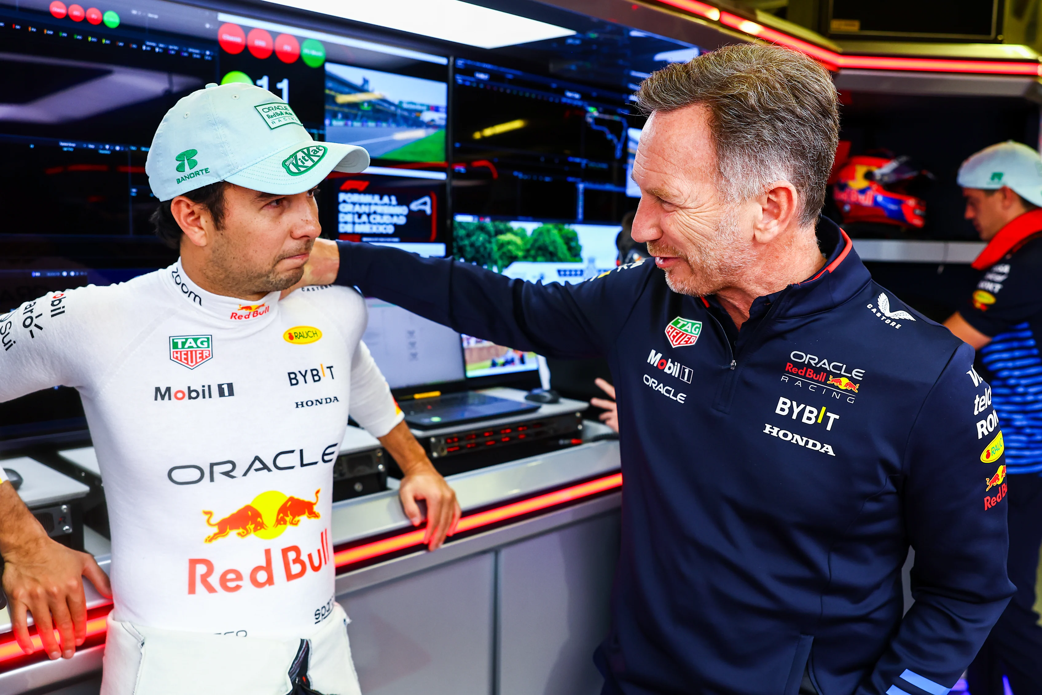 MEXICO CITY, MEXICO - OCTOBER 27: Sergio Perez and Oracle Red Bull Racing Team Principal Christian Horner talk in the garage prior to the F1 Grand Prix of Mexico on October 27, 2024 in Mexico City, Mexico. (Photo by Mark Thompson/Getty Images)