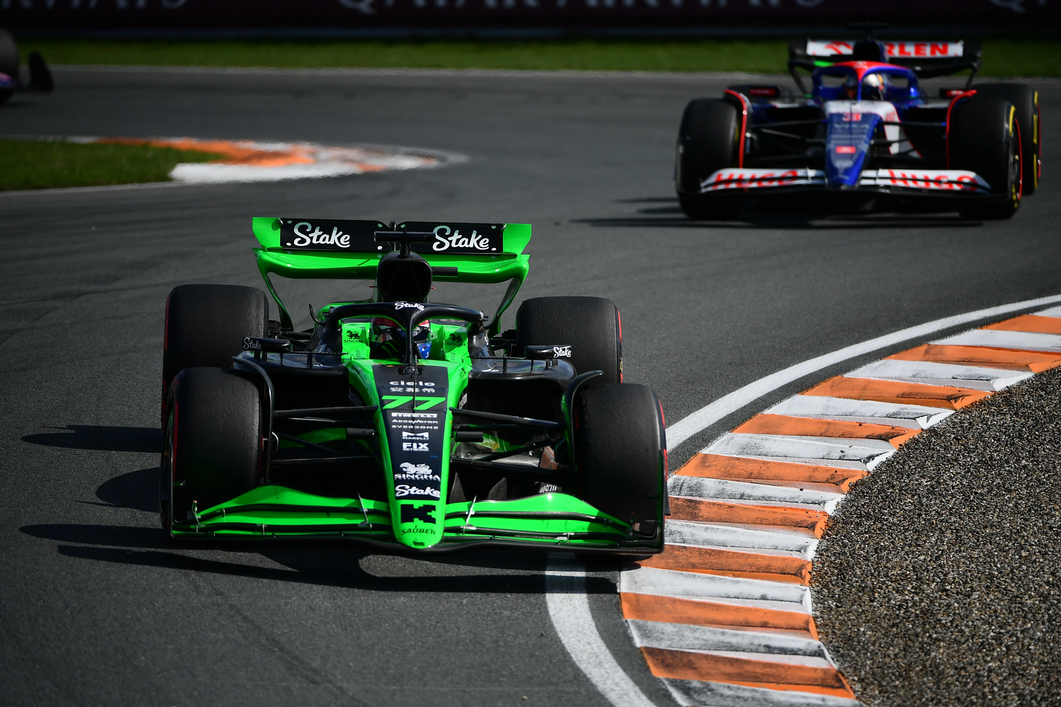 ZANDVOORT, NETHERLANDS - AUGUST 25: Valtteri Bottas of Finland driving the (77) Kick Sauber C44 Ferrari leads Daniel Ricciardo of Australia driving the (3) Visa Cash App RB VCARB 01 during the F1 Grand Prix of Netherlands at Circuit Zandvoort on August 25, 2024 in Zandvoort, Netherlands. (Photo by James Sutton - Formula 1/Formula 1 via Getty Images)