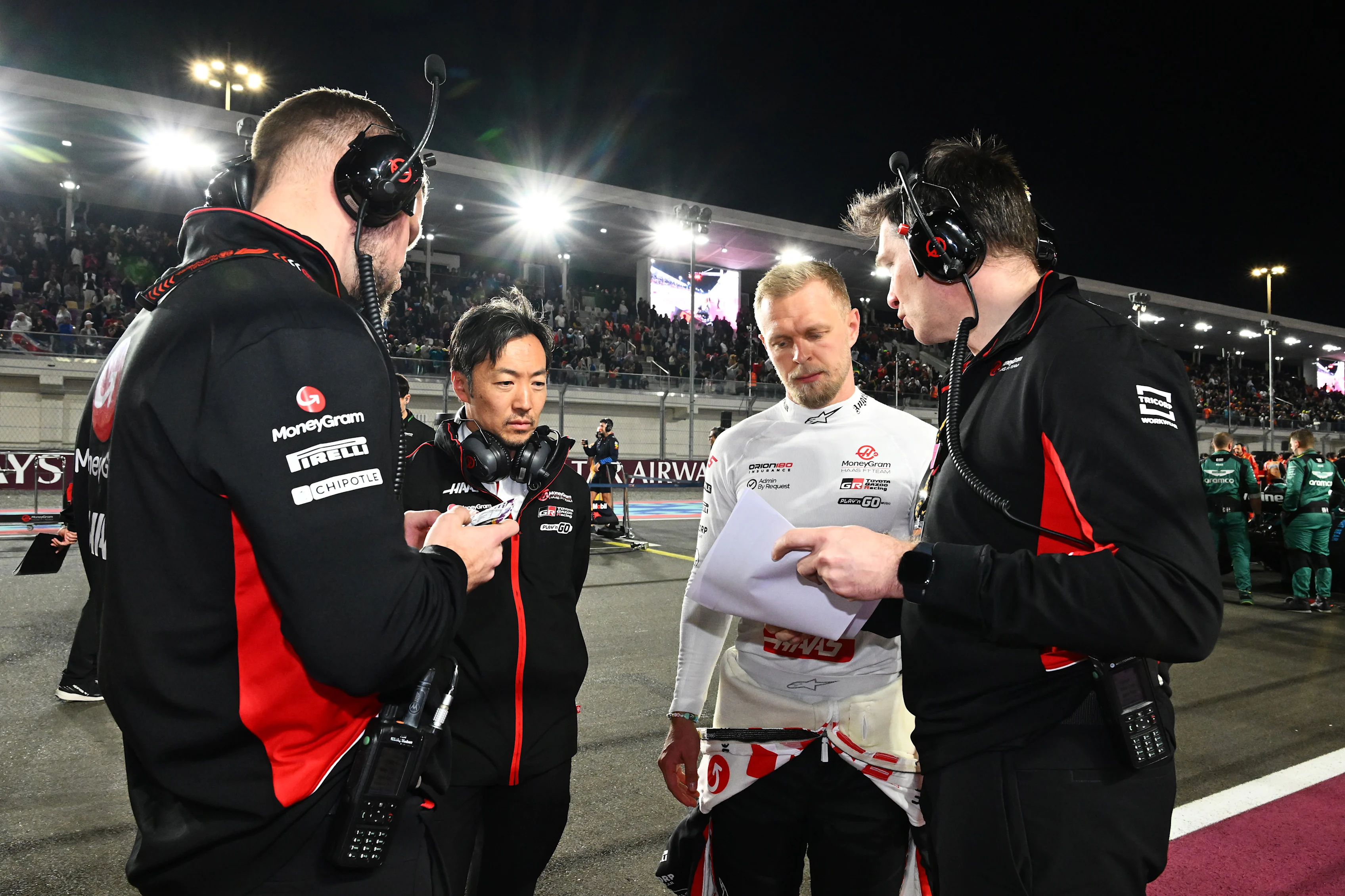 Kevin Magnussen and Ayao Komatsu talk with Haas F1 team members on the grid prior to the F1 Grand Prix of Qatar at Lusail International Circuit on December 01, 2024 in Lusail City, Qatar. (Photo by Mark Sutton - Formula 1/Formula 1 via Getty Images)