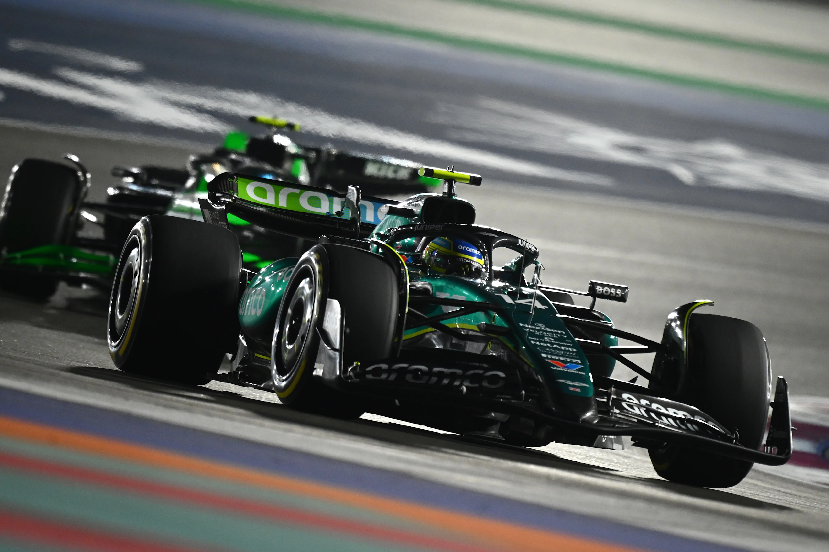 LUSAIL CITY, QATAR - DECEMBER 01: Fernando Alonso of Spain driving the (14) Aston Martin AMR24 Mercedes leads Zhou Guanyu of China driving the (24) Kick Sauber C44 Ferrari on track during the F1 Grand Prix of Qatar at Lusail International Circuit on December 01, 2024 in Lusail City, Qatar. (Photo by Clive Mason/Getty Images)