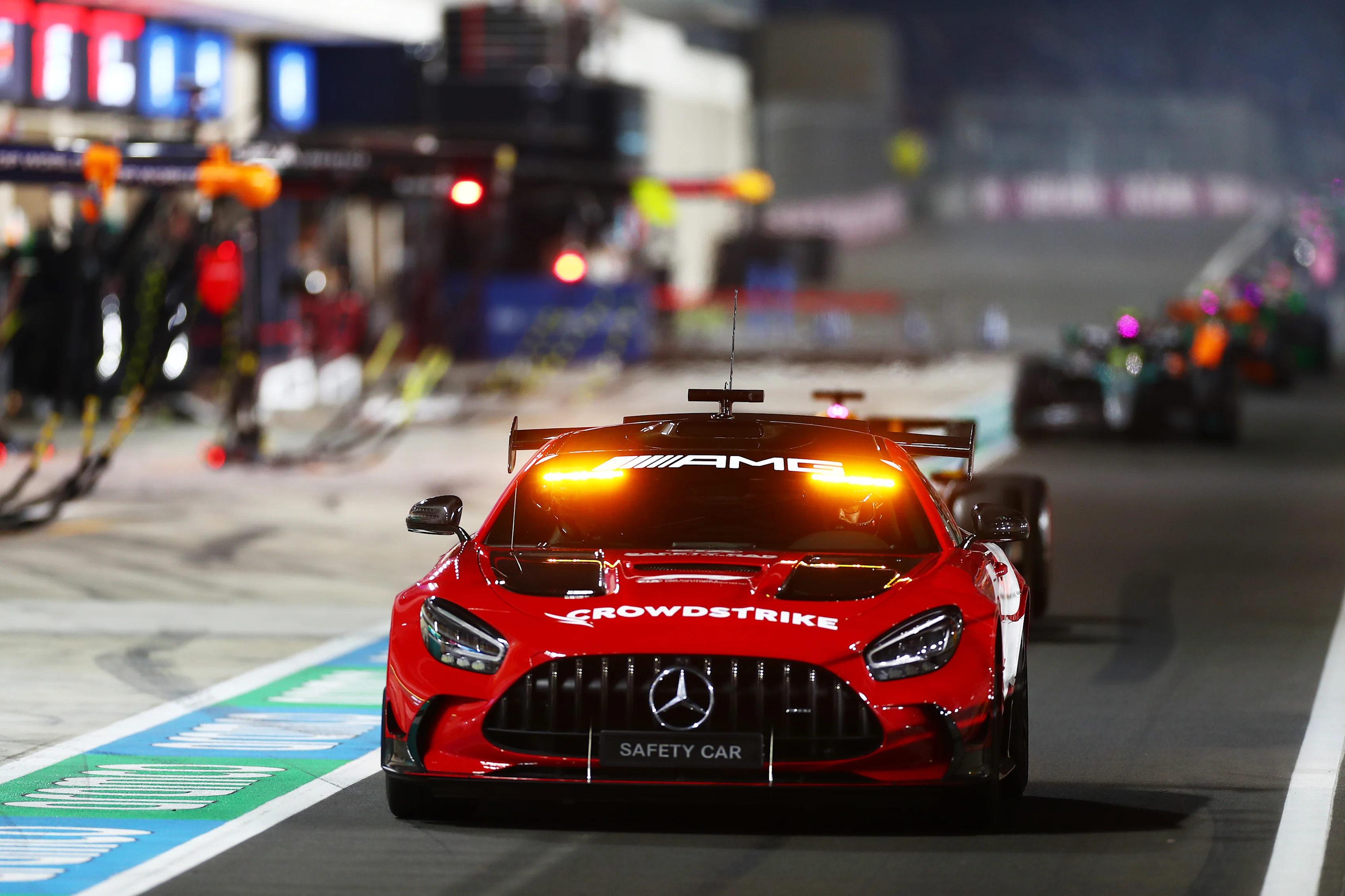 LUSAIL CITY, QATAR - DECEMBER 01: The FIA Safety Car leads the field down the Pit Lane during the