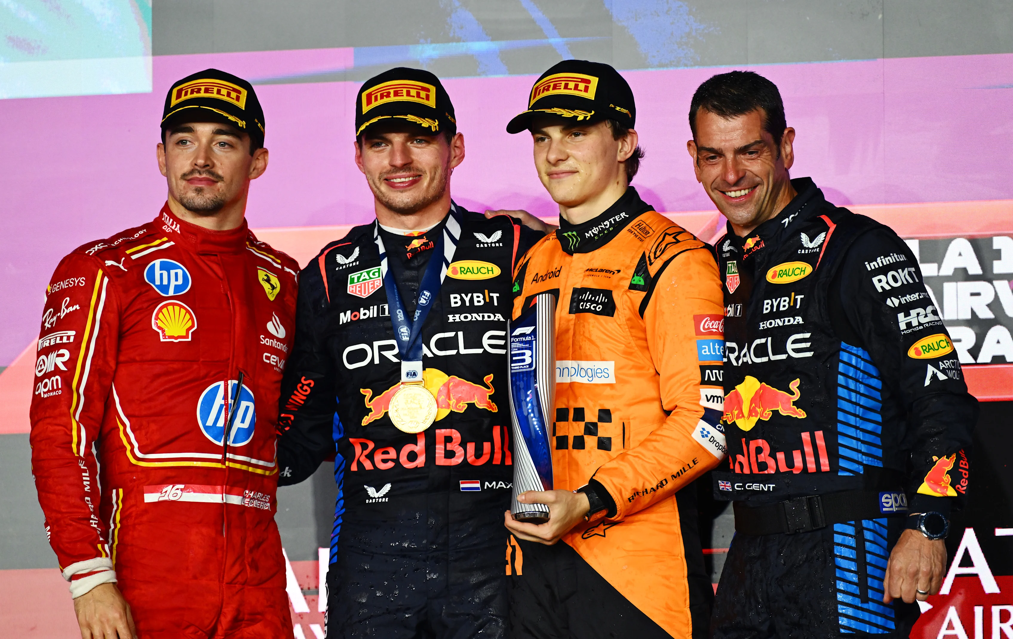 Max Verstappen, Second placed Charles Leclerc, Oscar Piastri and Chris Gent of Oracle Red Bull Racing (R) celebrate at Lusail International Circuit on December 01, 2024 in Lusail City, Qatar. (Photo by Mark Sutton - Formula 1/Formula 1 via Getty Images)