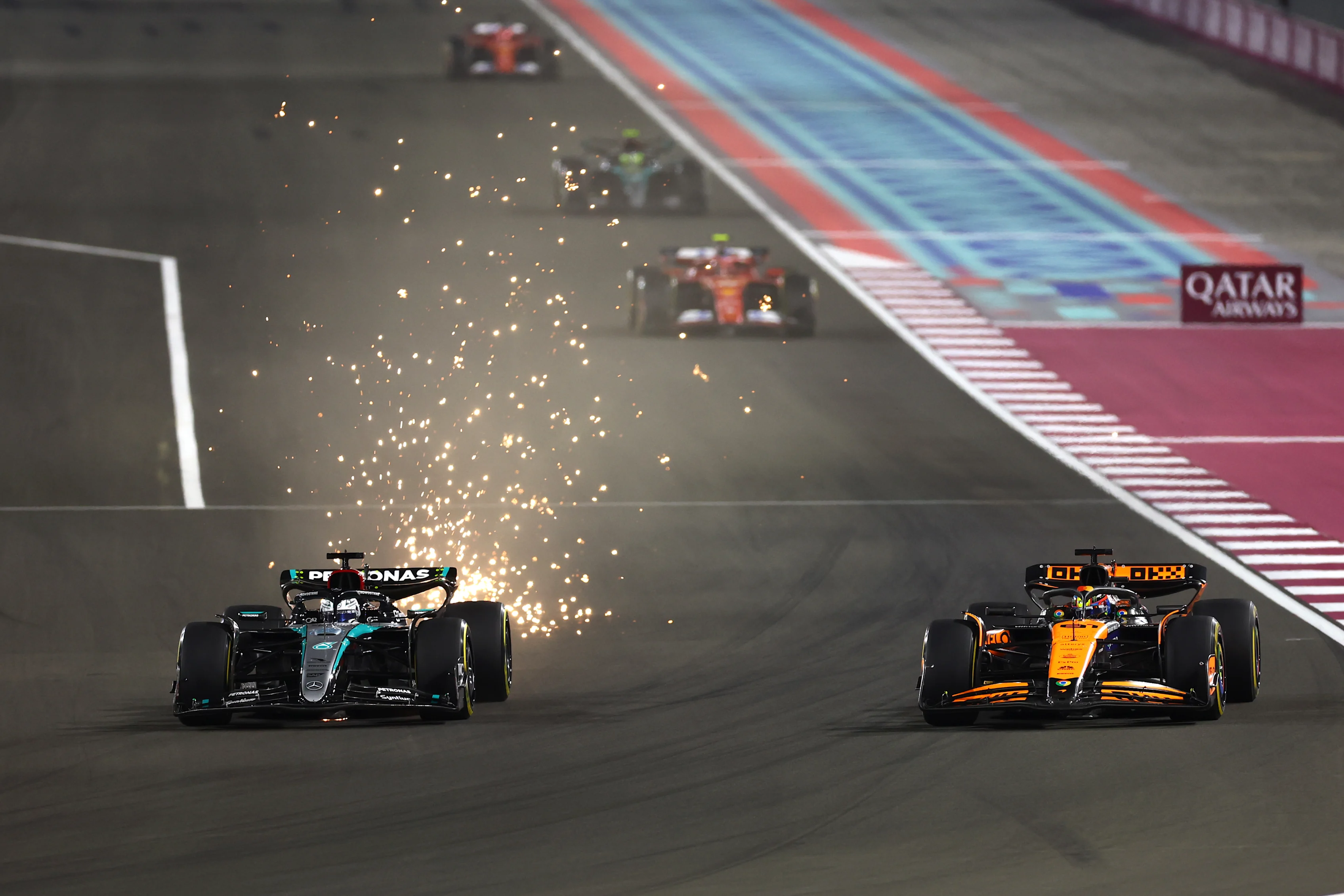 George Russell driving the (63) Mercedes W15 attempts an overtake on Oscar Piastri driving the (81) McLaren MCL38 Mercedes during the Sprint at Lusail International Circuit on November 30, 2024 in Lusail City, Qatar. (Photo by Mark Thompson/Getty Images)