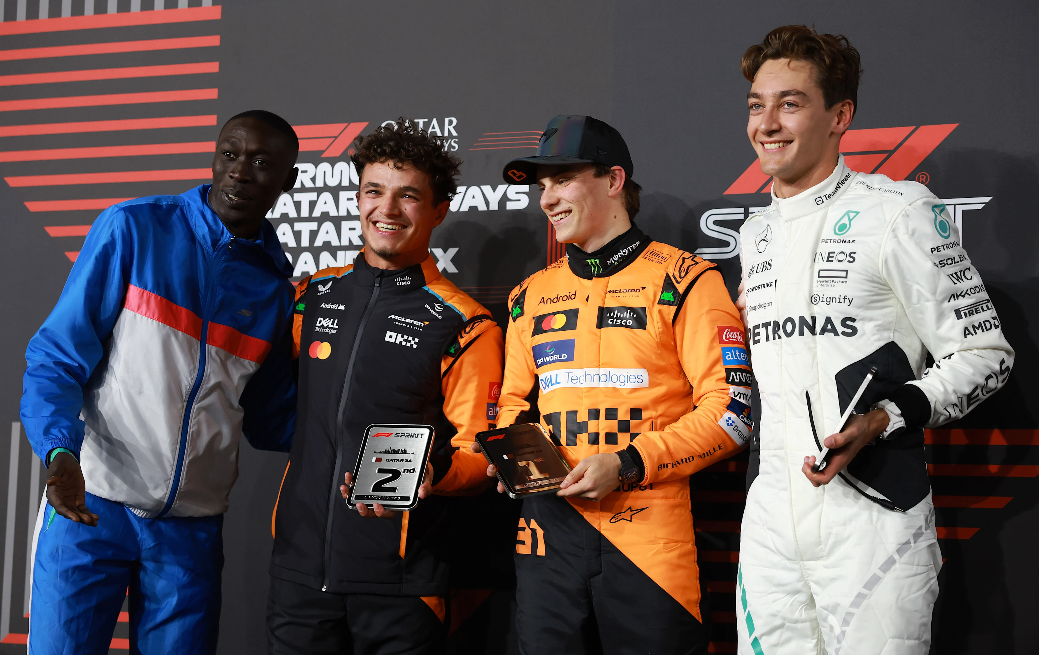 Sprint winner Oscar Piastri, Lando Norris, George Russell and Khaby Lame pose in the Paddock during the Sprint at Lusail International Circuit on November 30, 2024 in Lusail City, Qatar. (Photo by Bryn Lennon - Formula 1/Formula 1 via Getty Images)