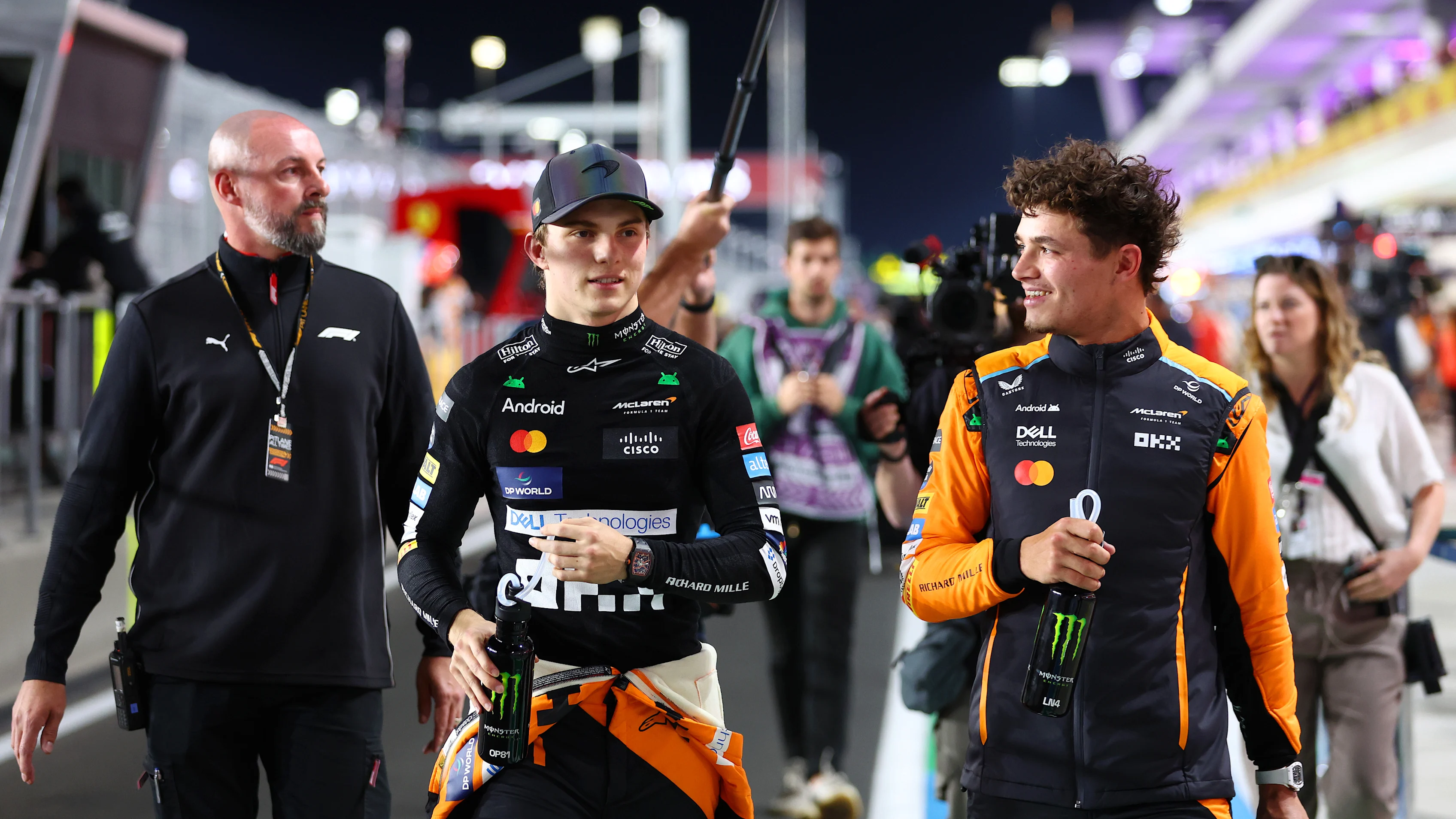 LUSAIL CITY, QATAR - NOVEMBER 30: Sprint winner Oscar Piastri of Australia and McLaren and Second placed Lando Norris of Great Britain and McLaren walks in the Pitlane after the Sprint ahead of the F1 Grand Prix of Qatar at Lusail International Circuit on November 30, 2024 in Lusail City, Qatar. (Photo by Bryn Lennon - Formula 1/Formula 1 via Getty Images)