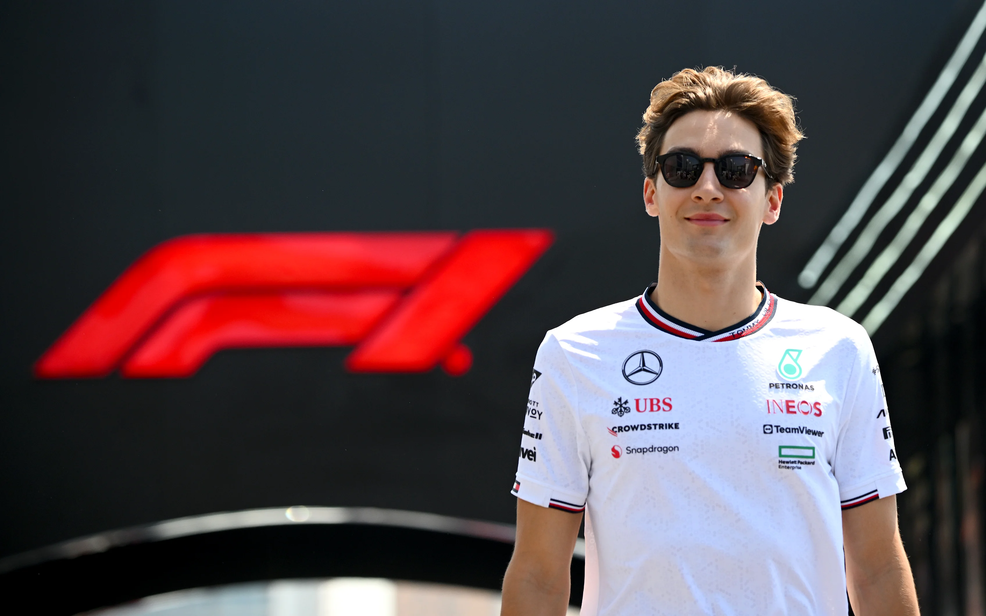 JEDDAH, SAUDI ARABIA - MARCH 06: George Russell of Great Britain and Mercedes walks in the Paddock