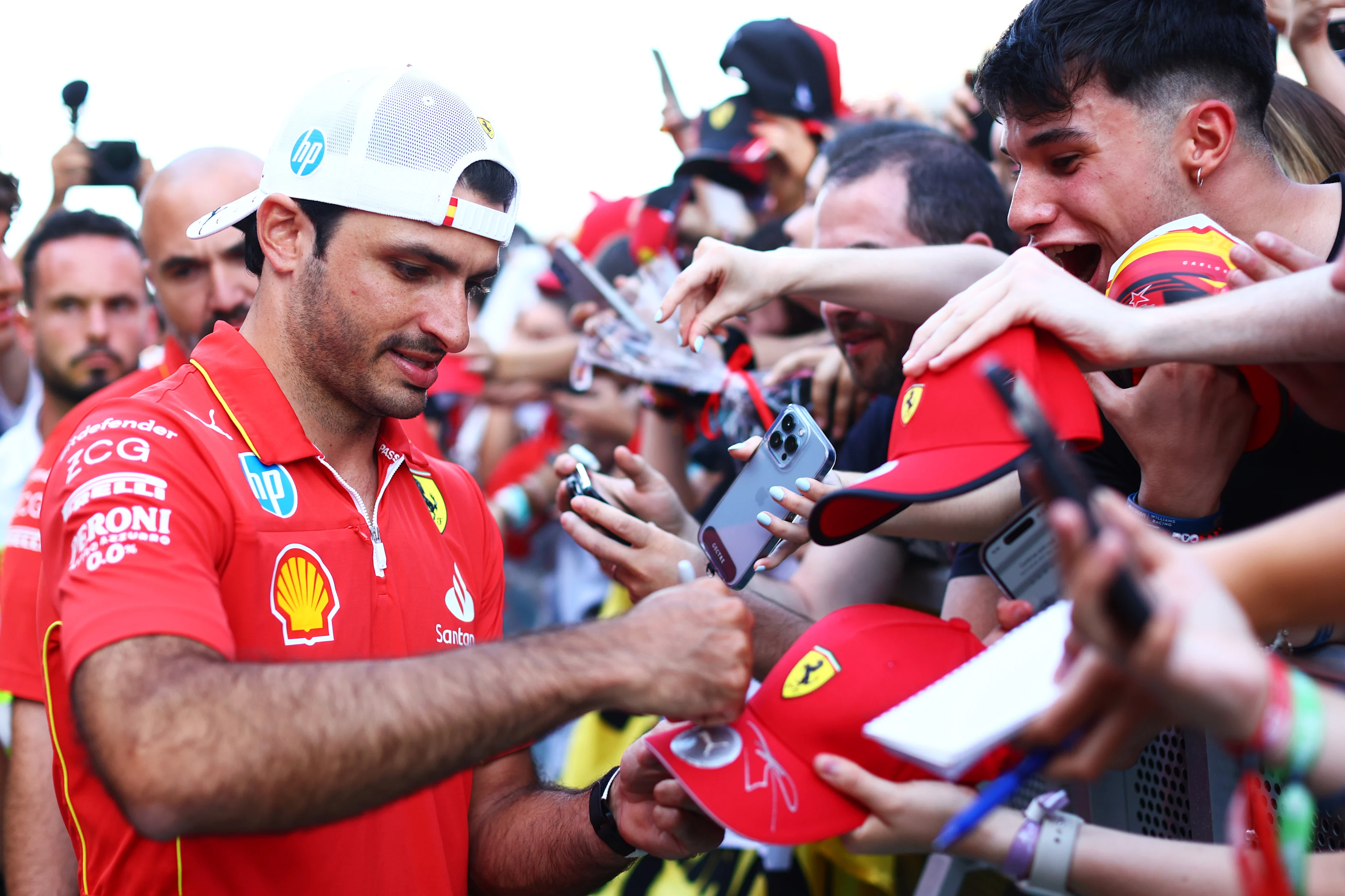 BARCELONA, SPAIN - JUNE 20: Carlos Sainz of Spain and Ferrari signs autographs for fans during